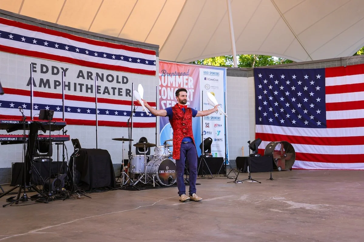 Professional juggler entertaining the crowd during a Fourth of July stage show at Brentwood's Red, White & BOOM festival.