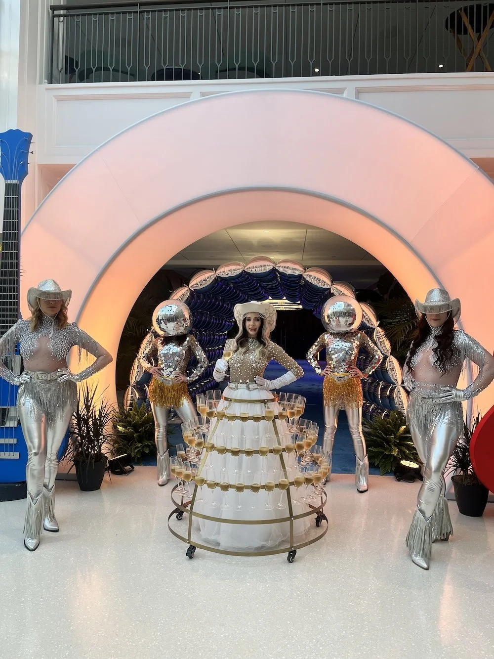 Strolling champagne skirt performer and disco ball dancers greeting guests for an event