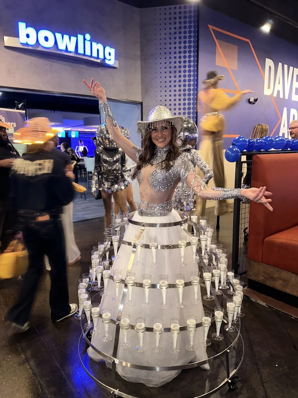 Champagne Skirt performer serving guests during a Nashville-themed corporate grand opening