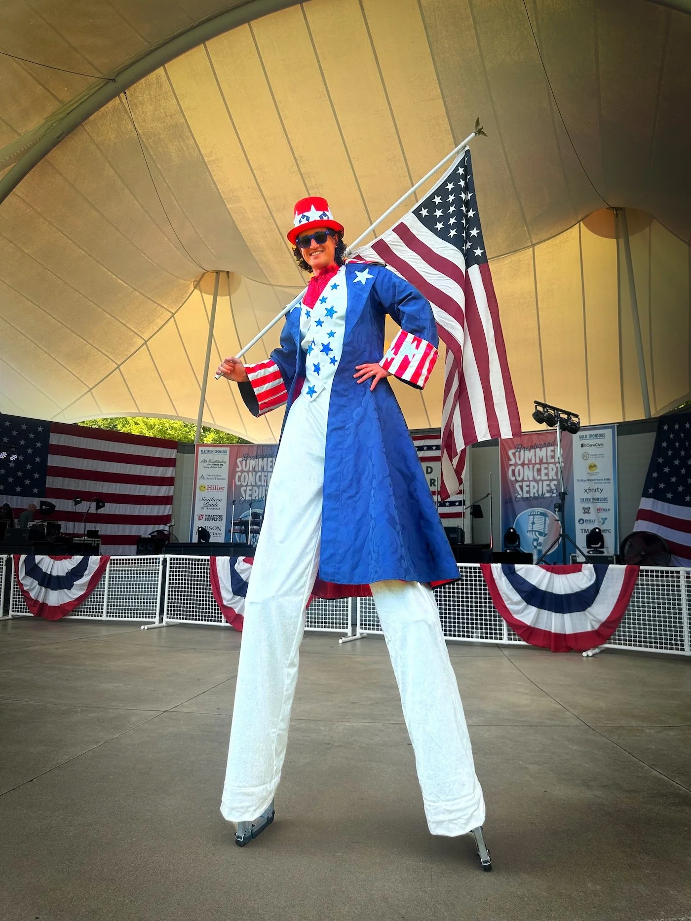Patriotic stilt walker posing with guests at the City of Brentwood Fourth of July festival.