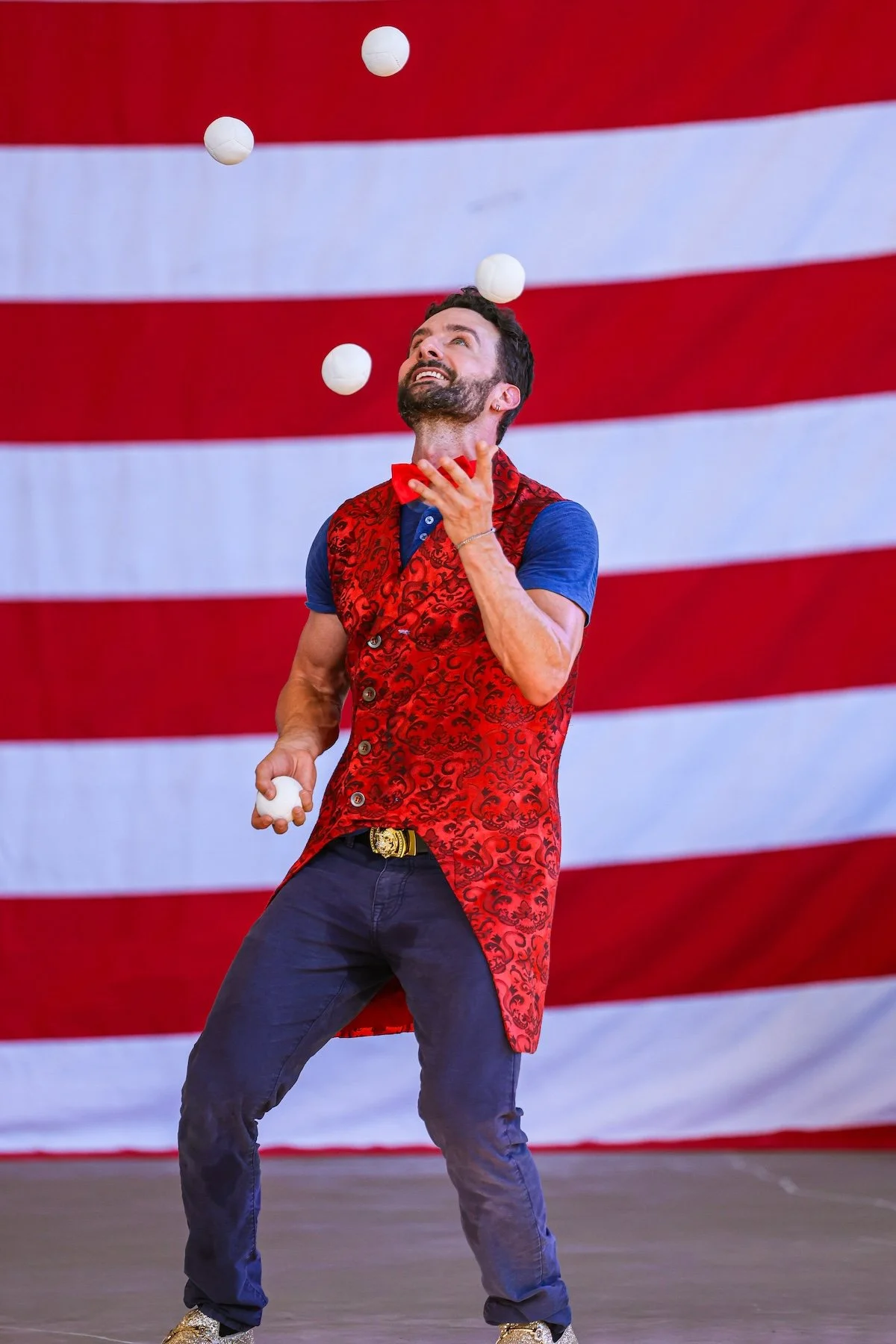 Professional juggler performing on stage at Crockett Park during Brentwood's Red, White & BOOM Independence Day celebration.