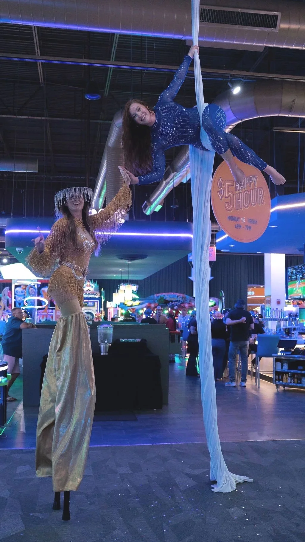 Country stilt walker and aerialist performing during a Nashville-themed corporate grand opening at Dave & Buster's.