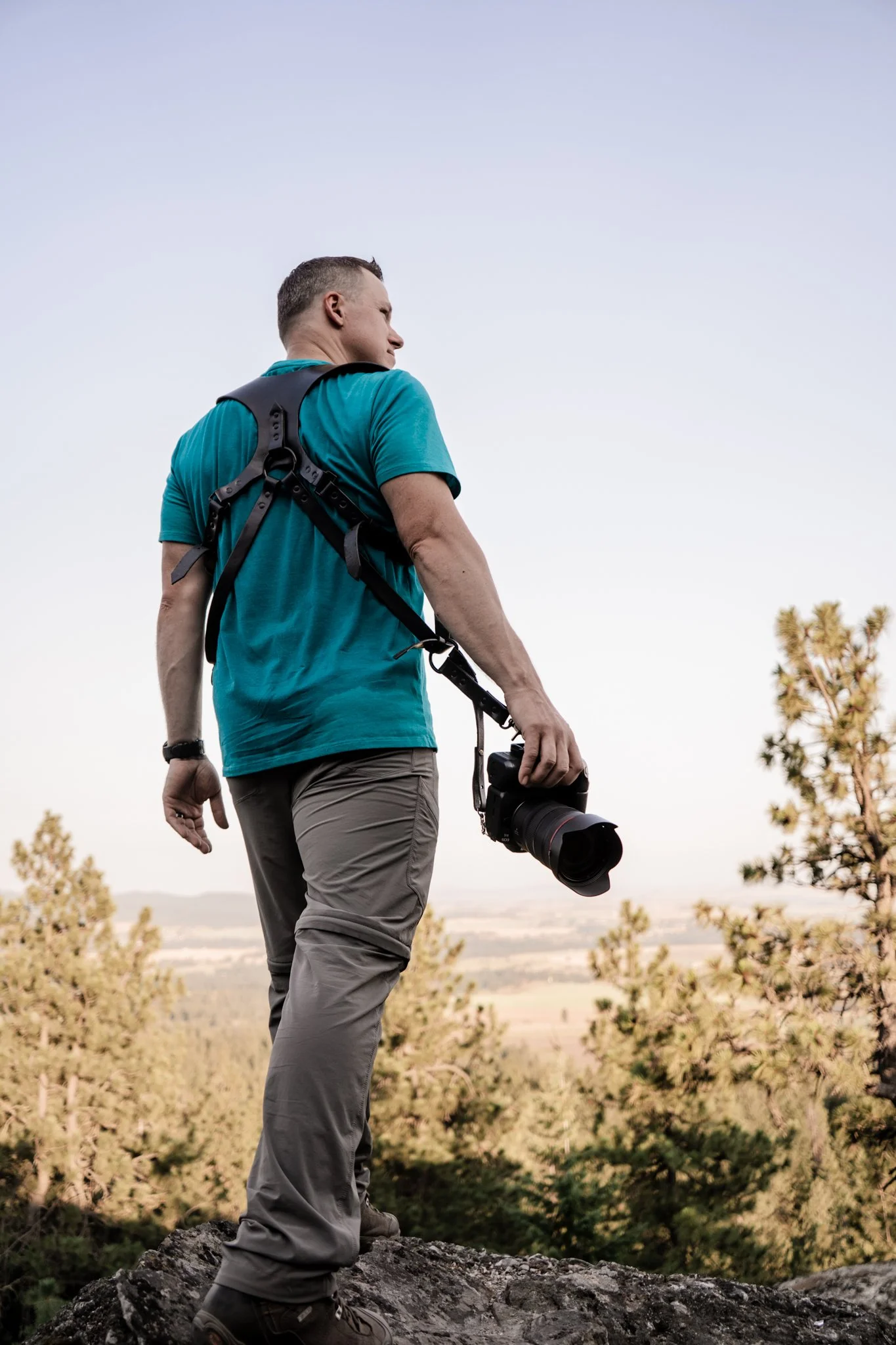Photograph of the photographer of life edit photography walking away with camera in hand and towards a view of the Palouse plains