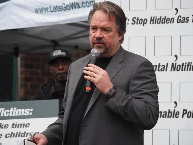 Mega-millionaire Brian Heywood in a grey suit 