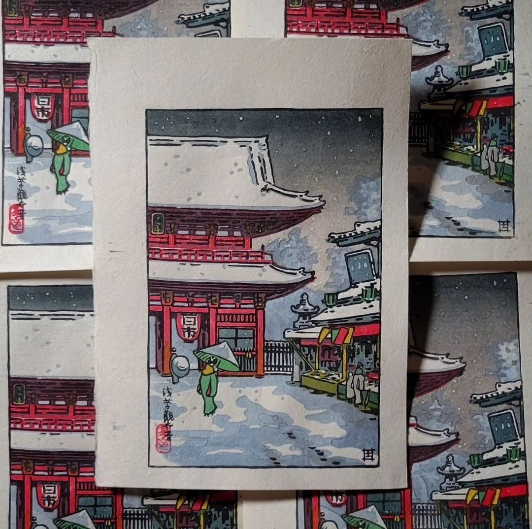 Both our inaugural print and our December Print of the Month! Based off of the original design by Tsuchiya Koitsu, this winter scene depicts several temple vistors walking amongst the temple grounds as a light snow falls. This print required 10 separ