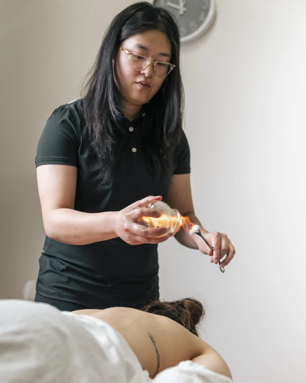 Acupuncturist performing cupping therapy at Panda Revival Lab in Surrey