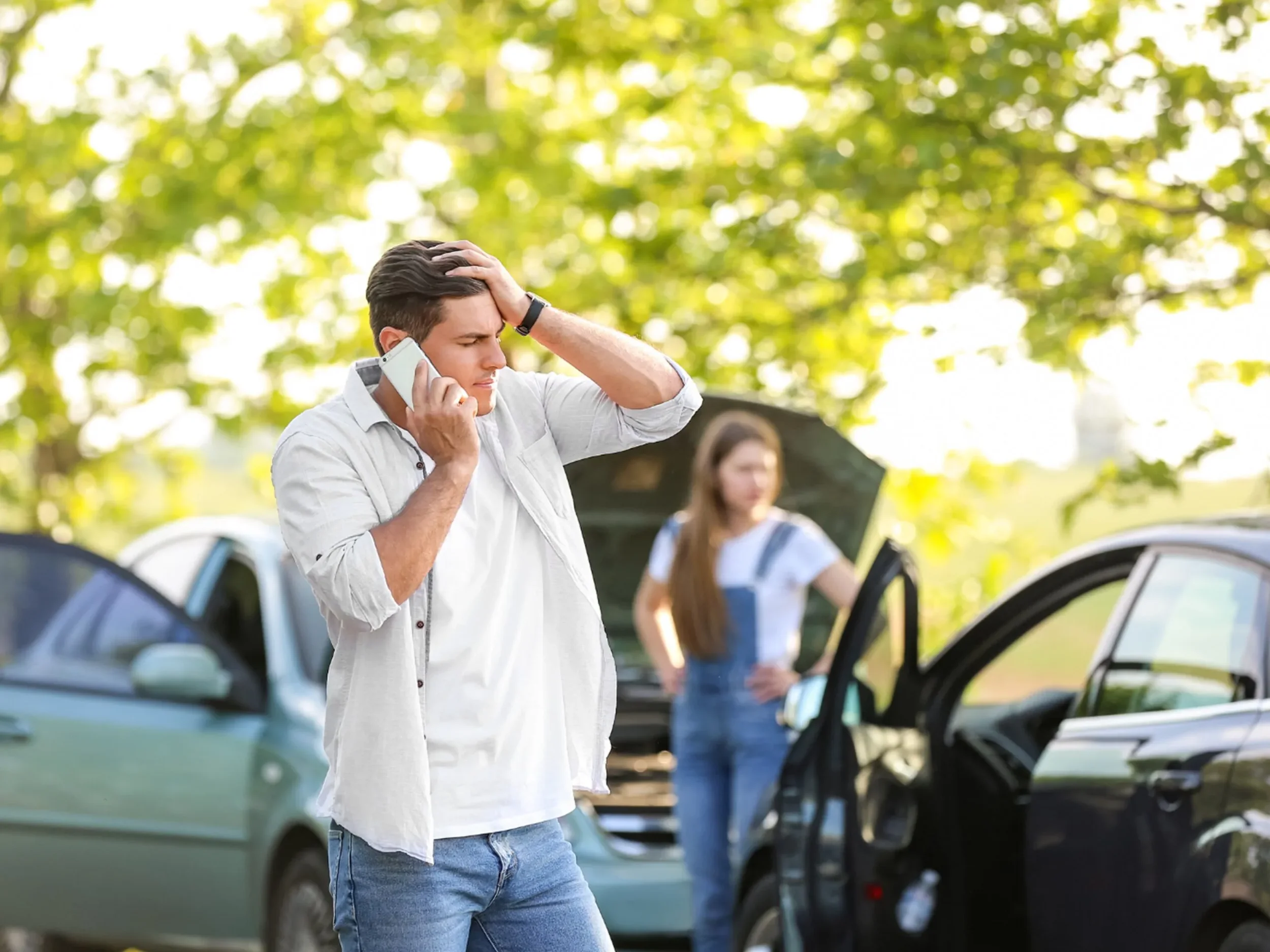 Stressed driver holding his head while on the phone after a car accident, needing ICBC accident rehab in Surrey