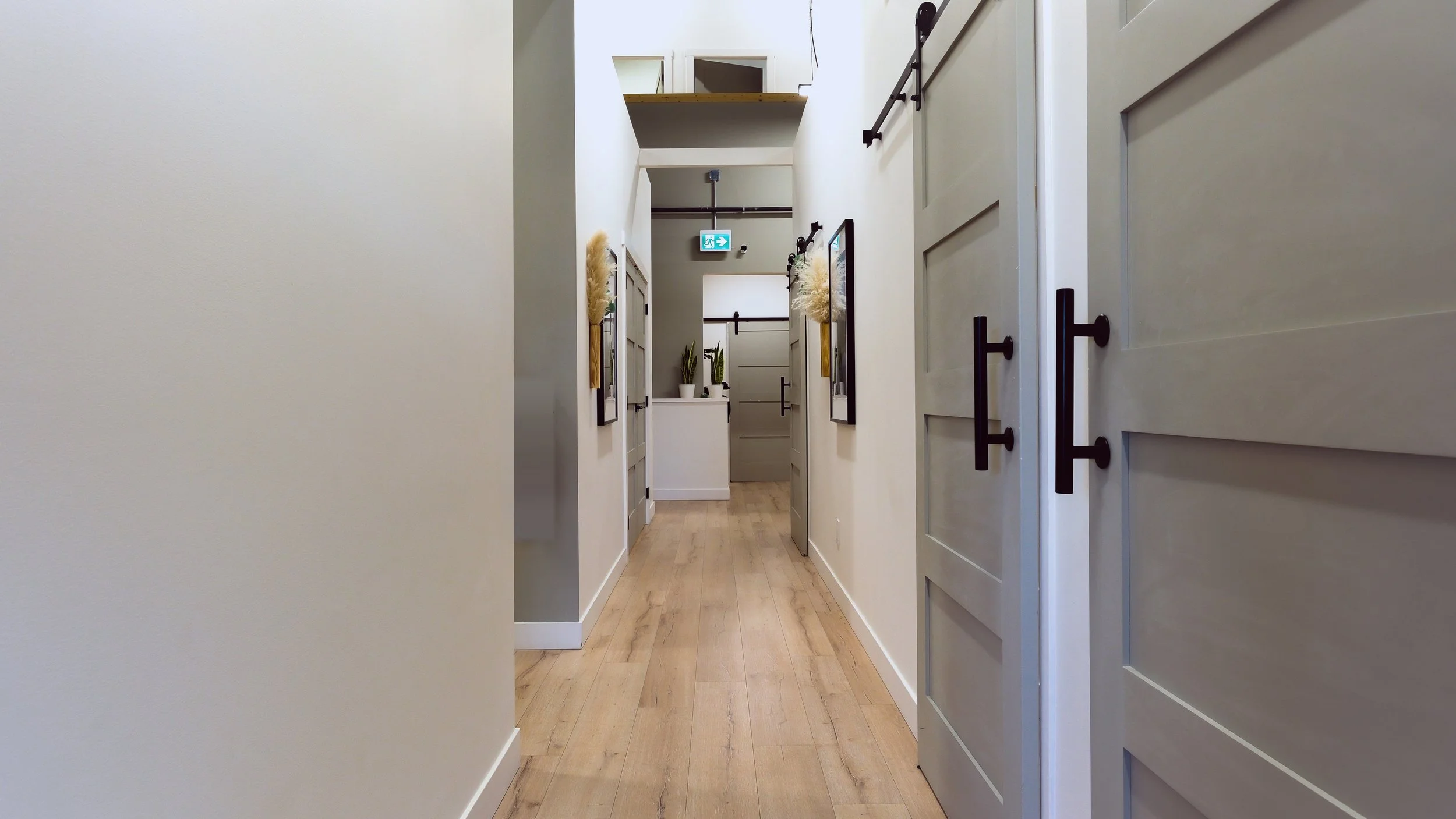 Hallway leading to private treatment rooms at Panda Revival Lab in Fraser Heights, Surrey