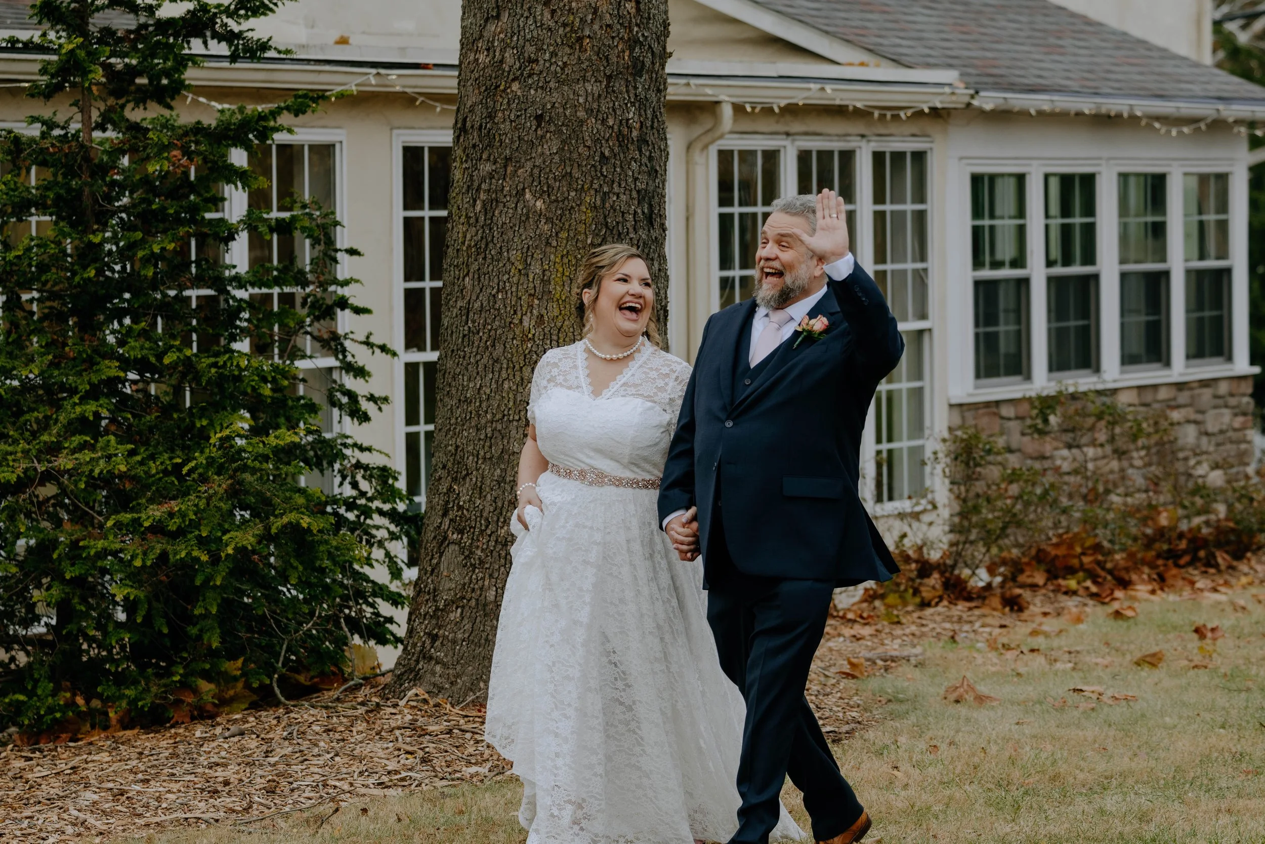 Candid photo of bride and groom walking at the Rising Sunn Inn Bethlehem PA captured by Black Pearl Moments photography.