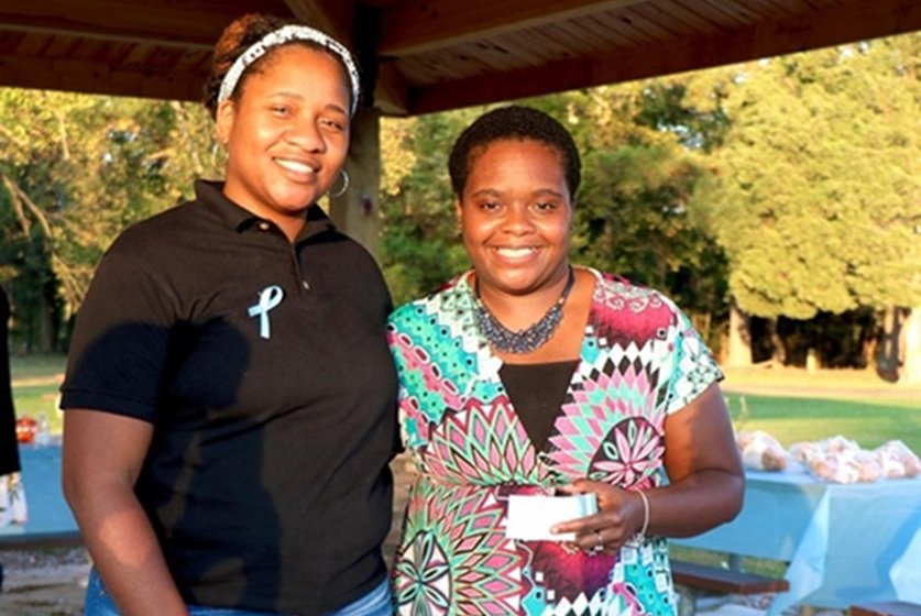 Michelle Allette, mother of Elijah and founder of Elijah's Purpose, standing with a client at an event