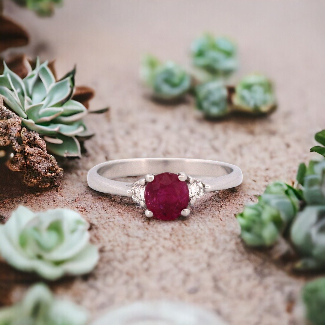 Swipe to experience the allure of our ready to wear collection, meticulously crafted to demure perfection. This exquisite ruby ring, set in lustrous 18K white gold and flanked by sparkling diamonds, symbolizes love and passion. Each gem is carefully 