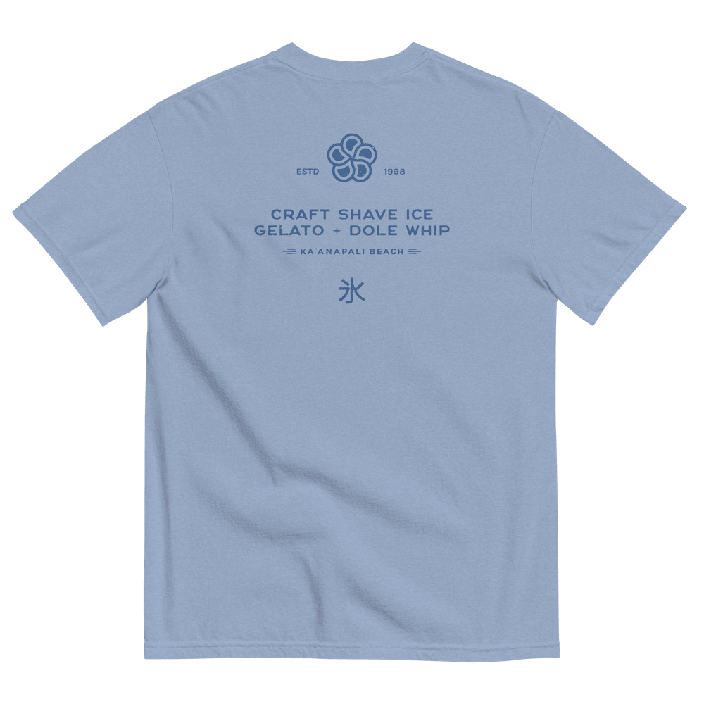 The back of a medium blue t-shirt with the HulaScoops flower mark above the text “Craft Shave Ice, Gelato and Dole Whip” and the Japanese symbol for kakigori all printed in a darker blue color.