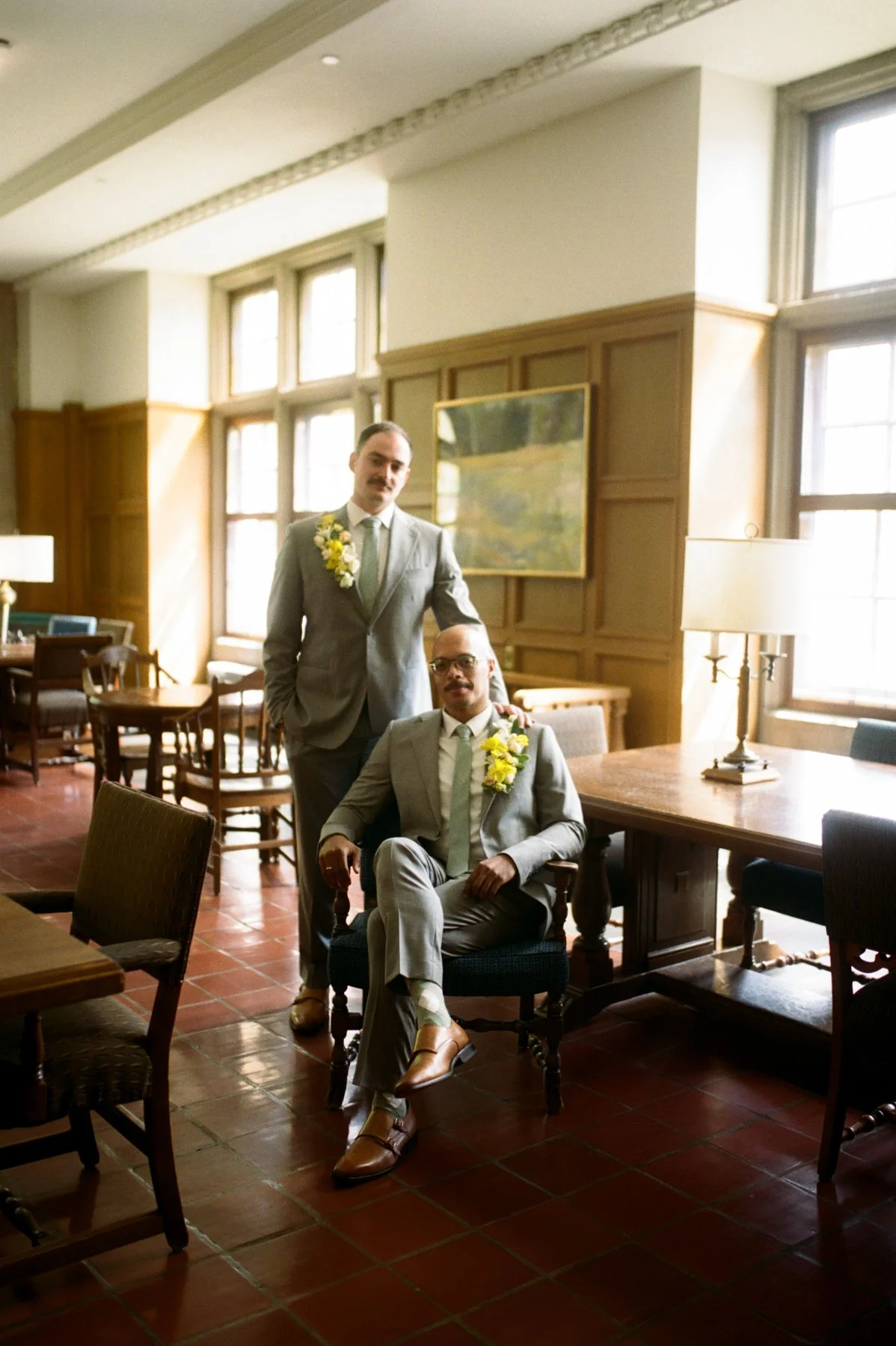 Two grooms pose for queer wedding portrait