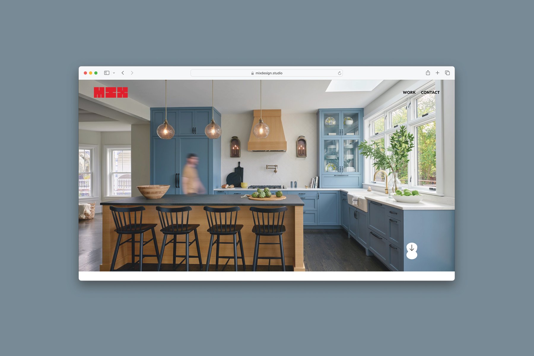 A webpage showcasing a modern kitchen with blue cabinets, black island, four bar stools, and large window.
