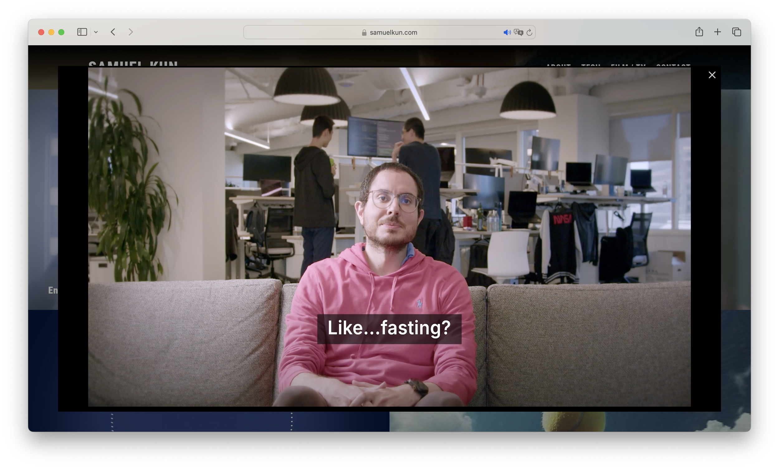 Screenshot of the homepage for Samuel Kin showing a video opened up in a Lightbox with a man talking with subtitles.