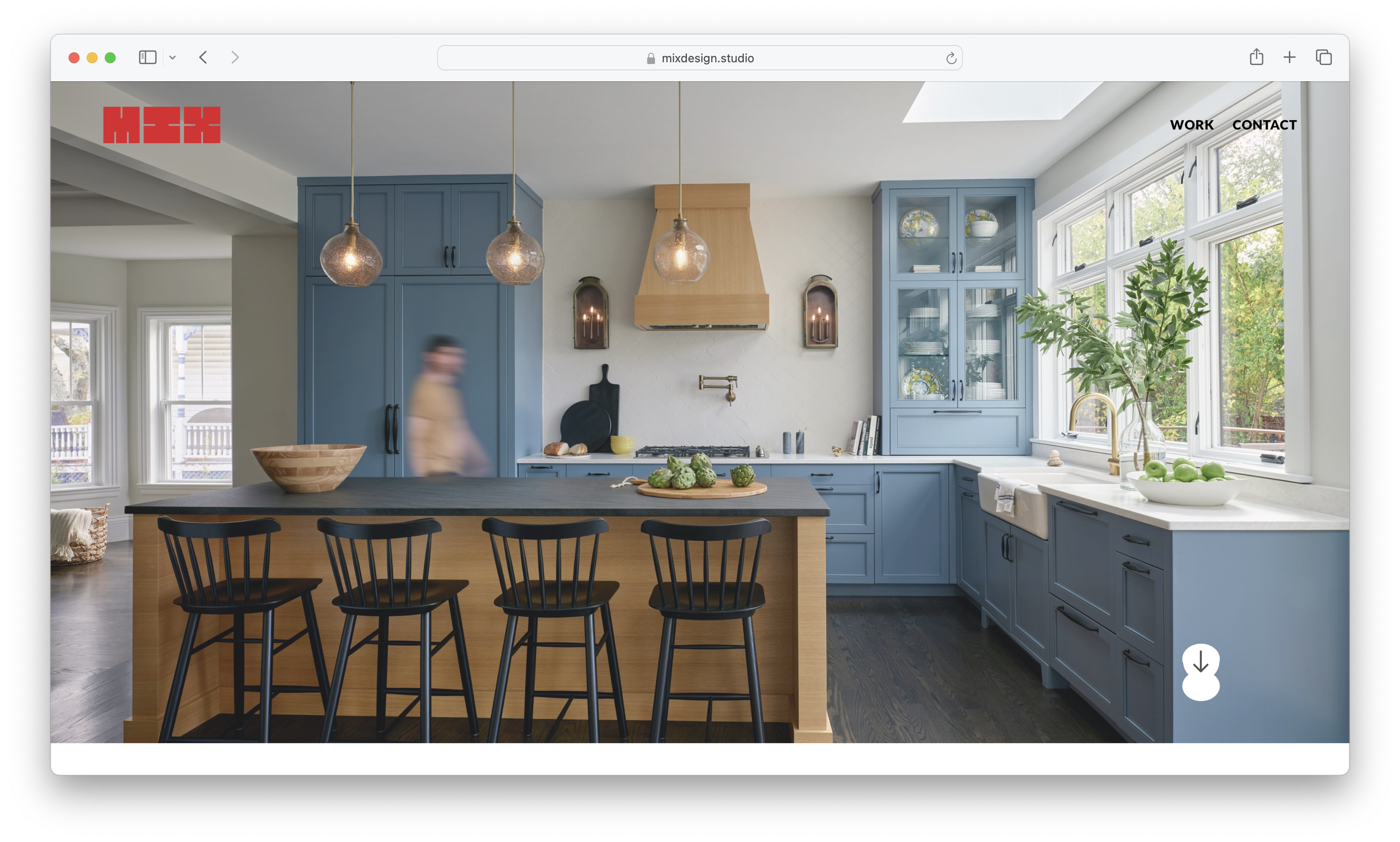 Screenshot of the homepage for Mix Design Studio featuring an image of a modern kitchen with blue cabinets, a kitchen island with a black countertop, black barstools, hanging pendant lights, and a large window.