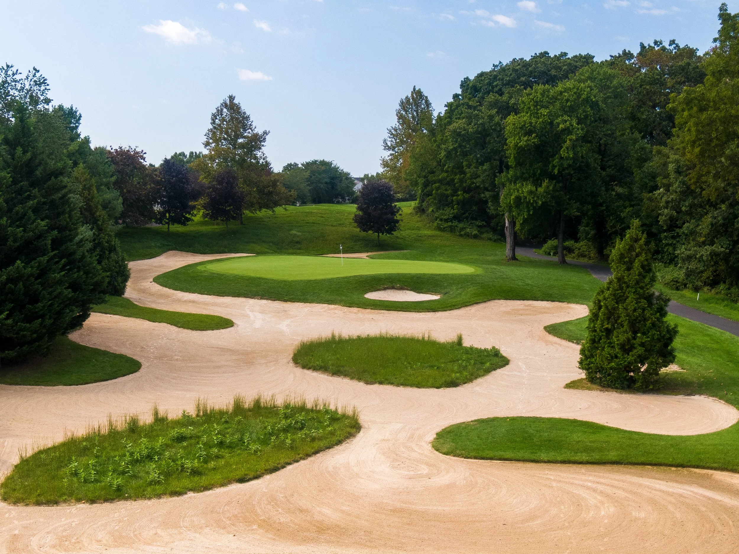 The short Par 3 at Talamore Country Club challenges distance control with a shallow green surrounded by bunkers