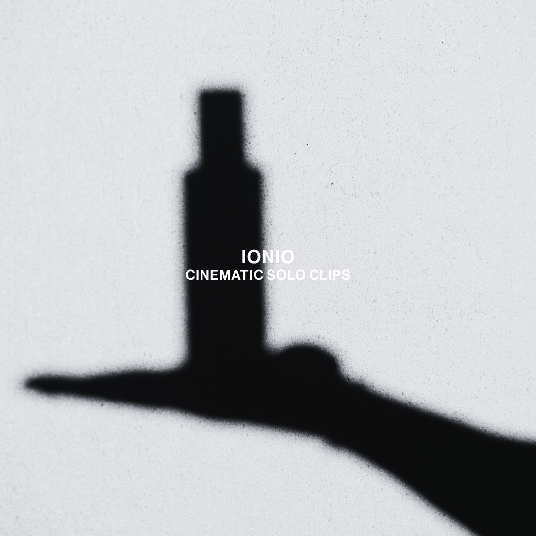 The dark shadow of an IONIO bottle resting on someone's flat palm