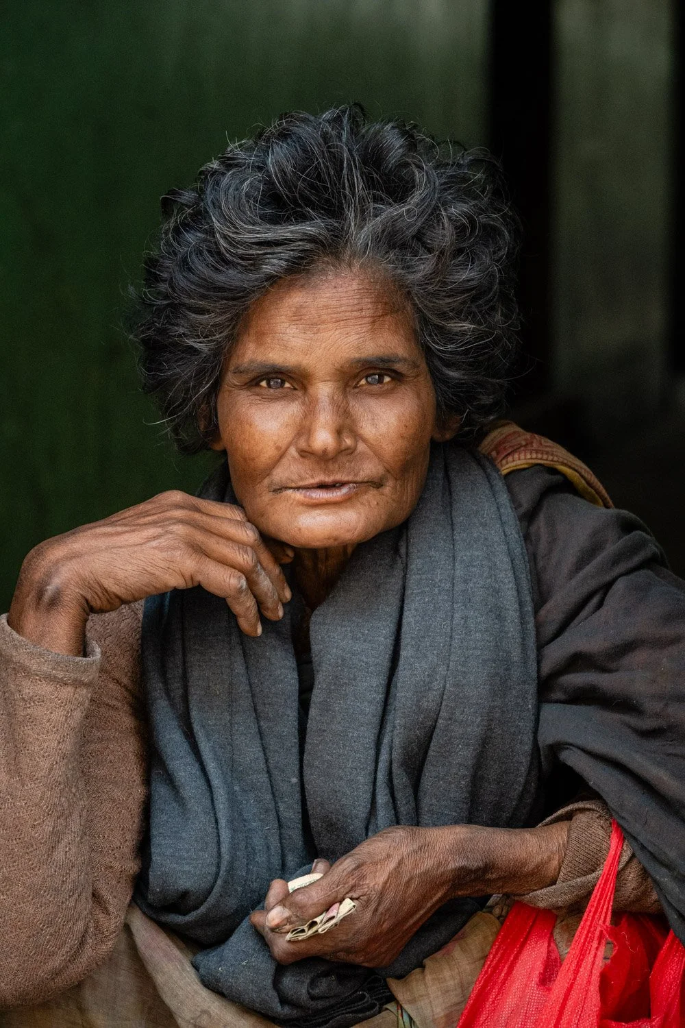 She was walking through the market in the street of Dhaka Bangladesh and I asked her to sit for a portrait. 