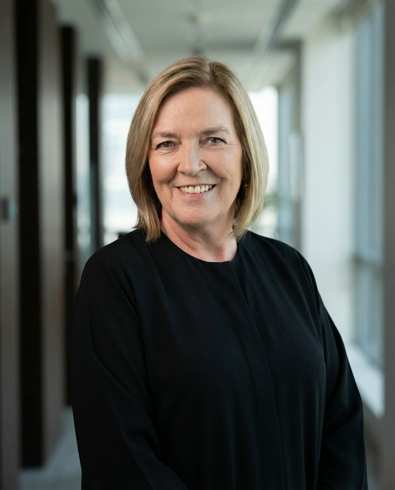 Jacky Carter sitting with hands clasped in front.