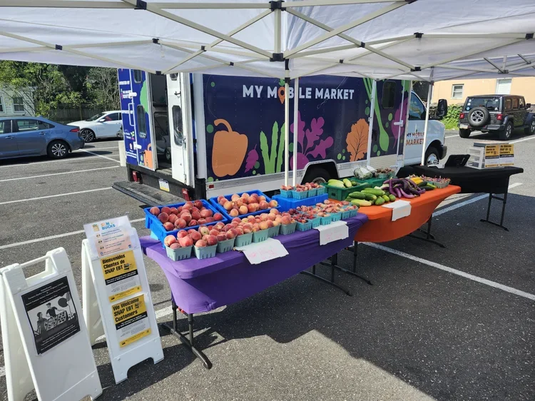Side profile of mobile market truck with fruit display