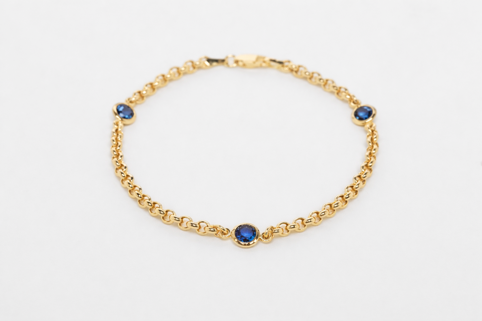 Elegant gold bracelet with blue sapphires.png