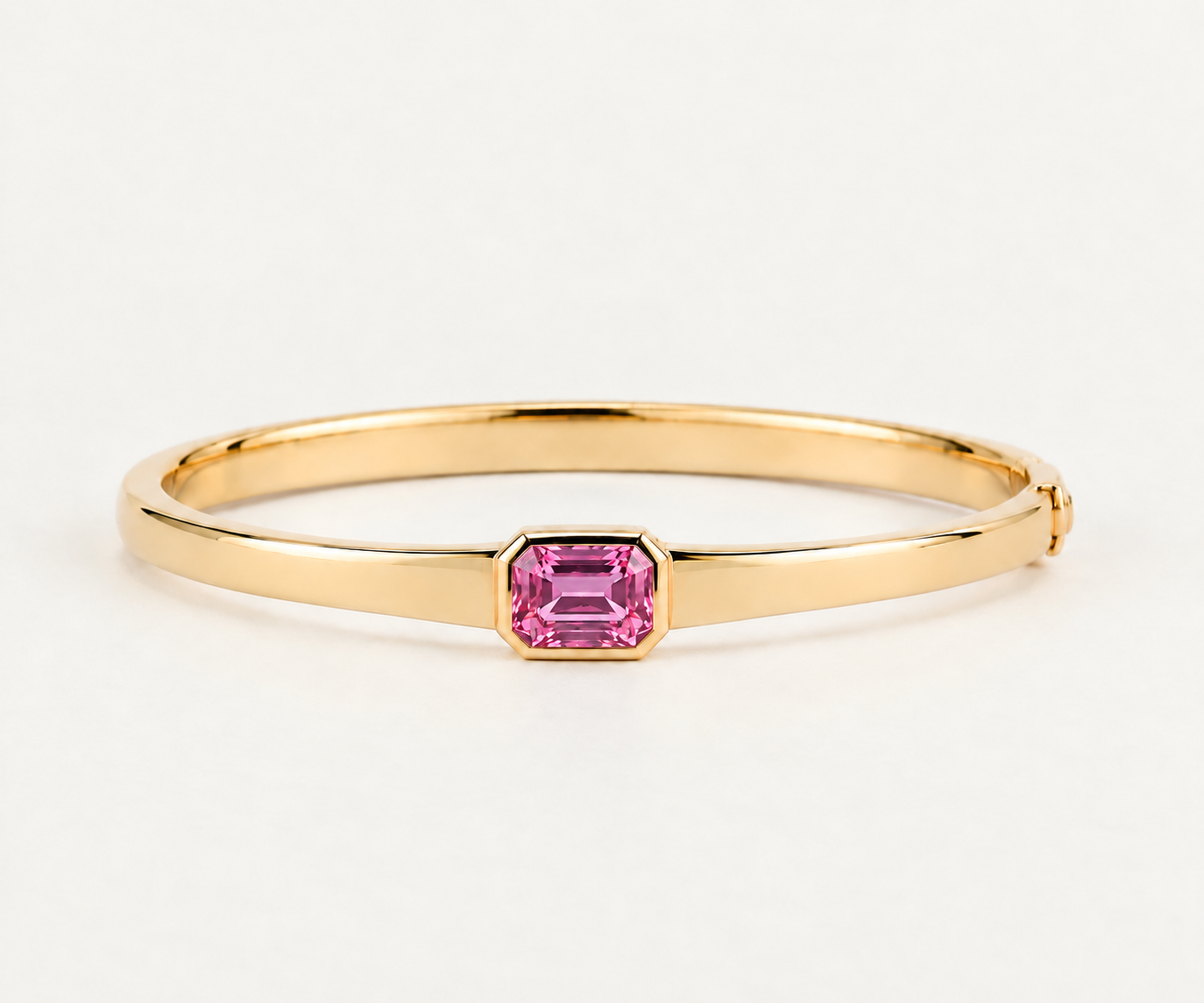 Polished Gold Bangle with Pink Gemstone.png