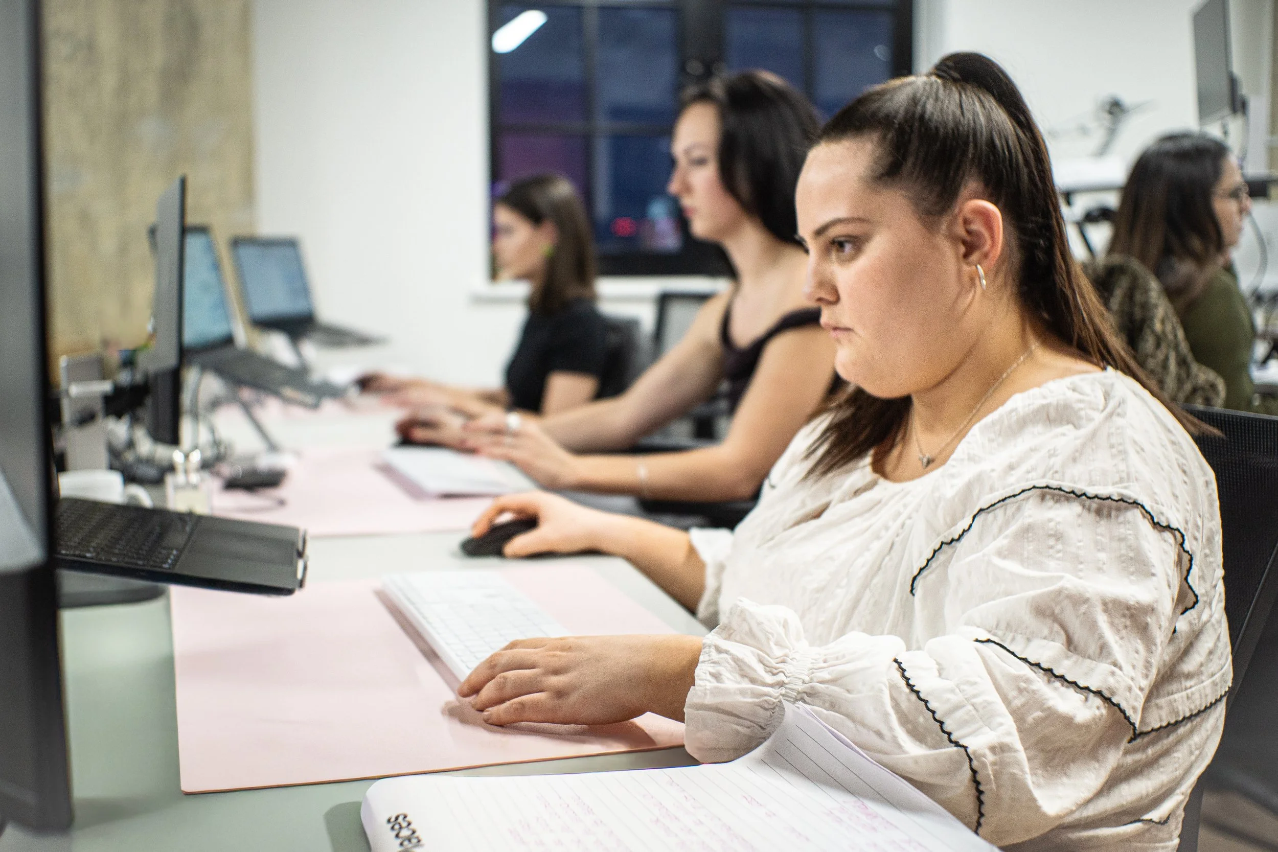 Women working at computers in an office.