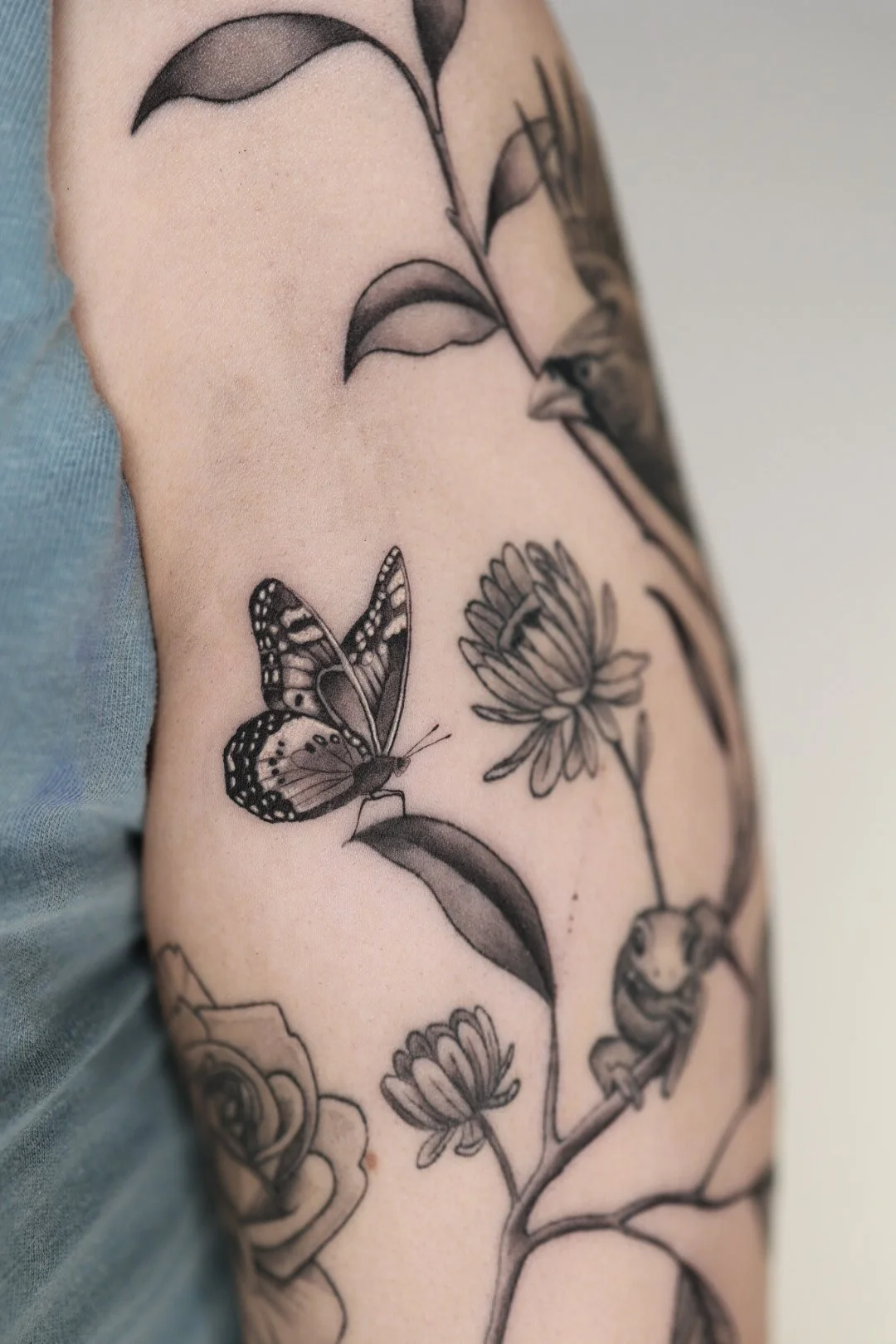 Butterfly and floral tattoo