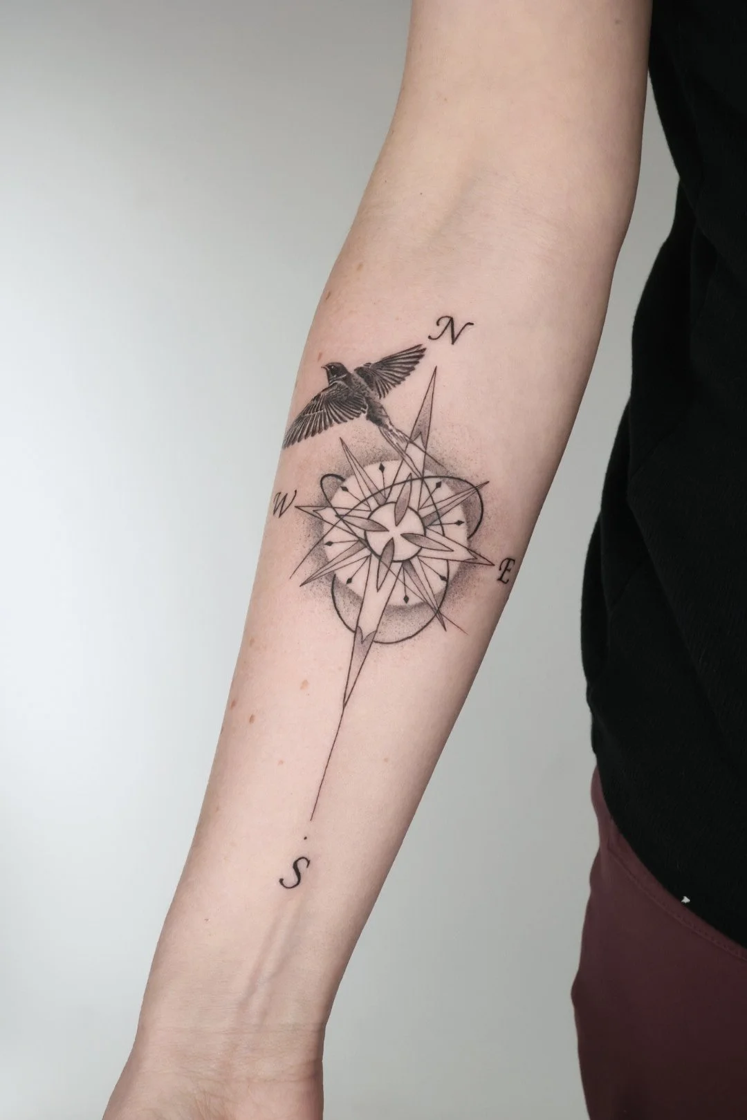 Bird and compass tattoo