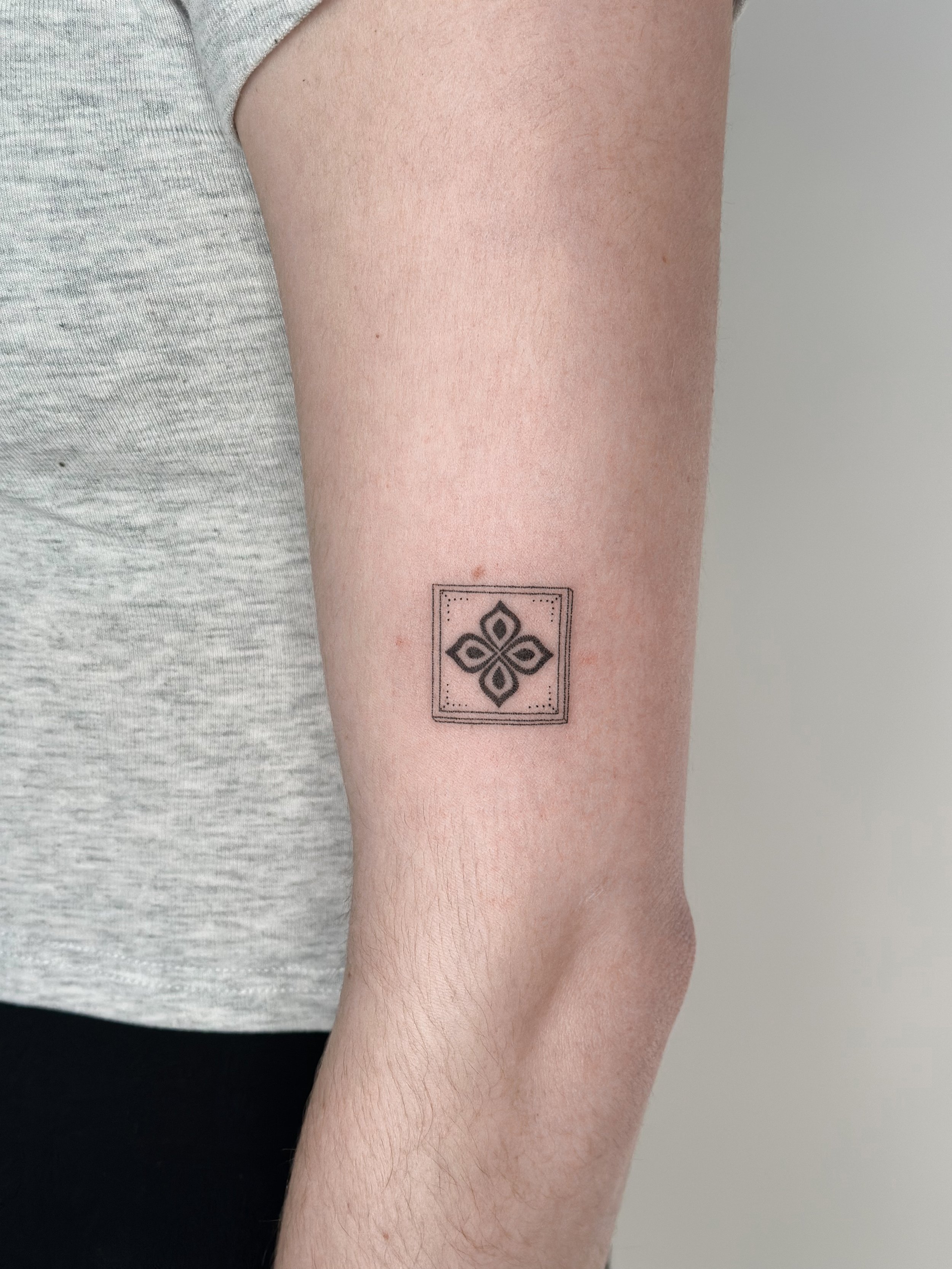 Geometric tattoo with floral pattern on arm