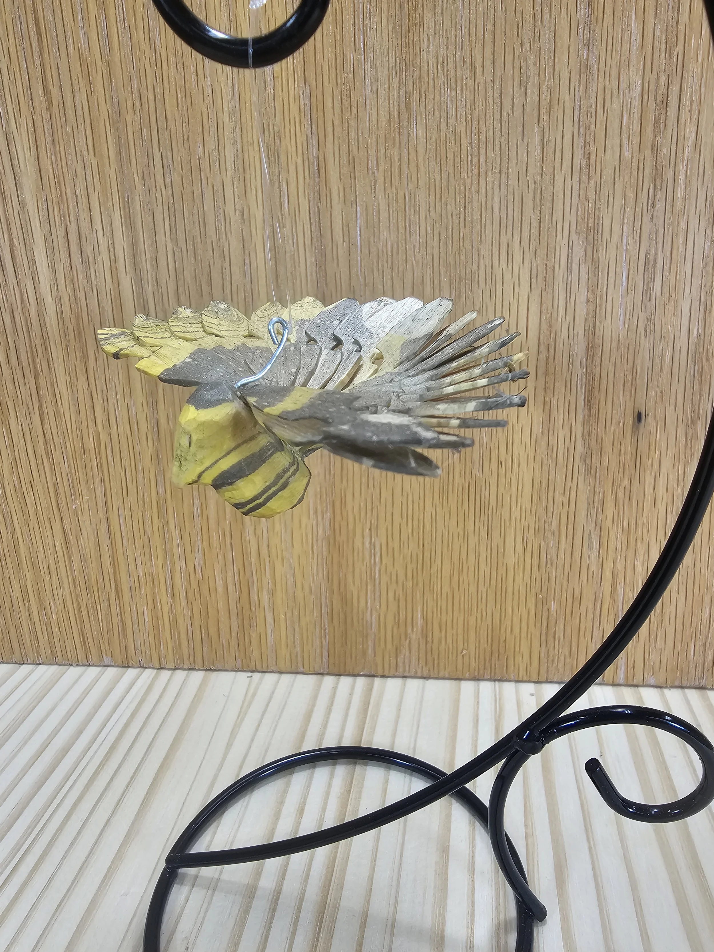 Small black & yellow fan bird with stand