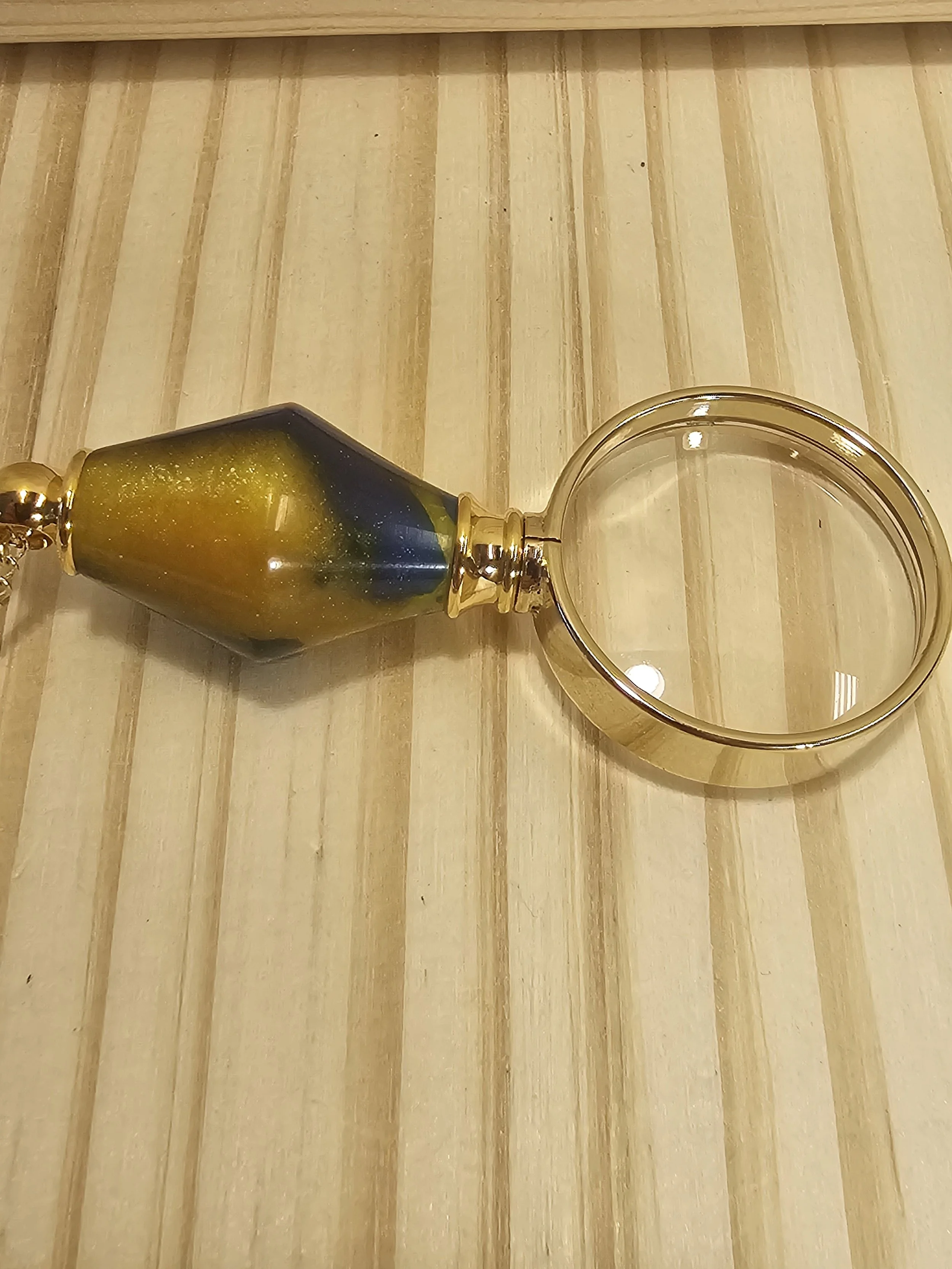 Magnifying Glass Pendant with glittery gold & blue polyresin