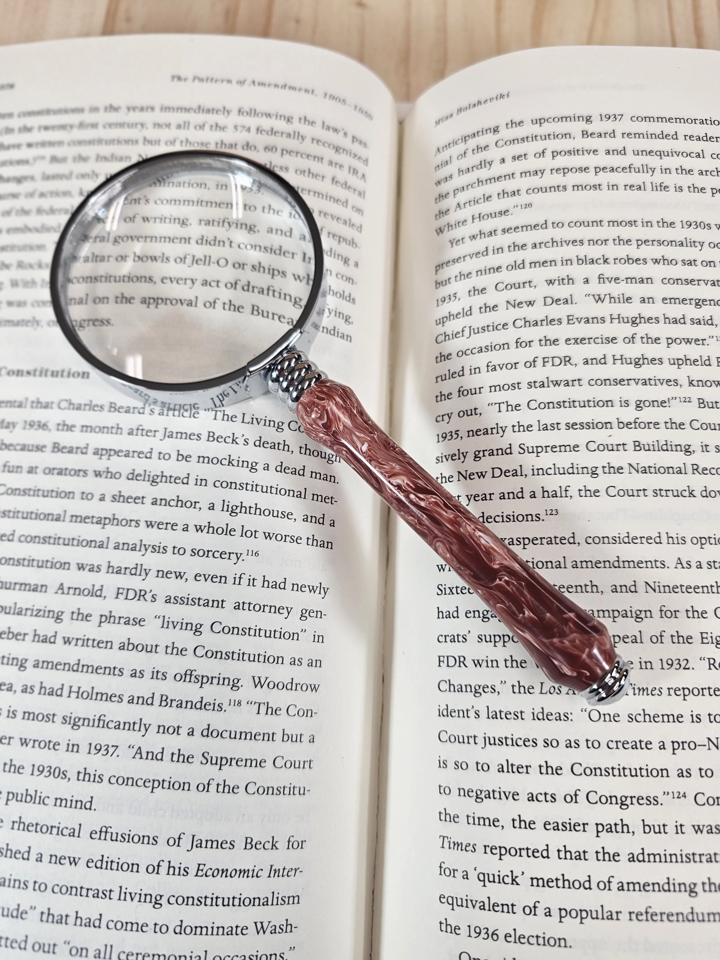 Magnifying Glass with crimson and cream colored polyresin