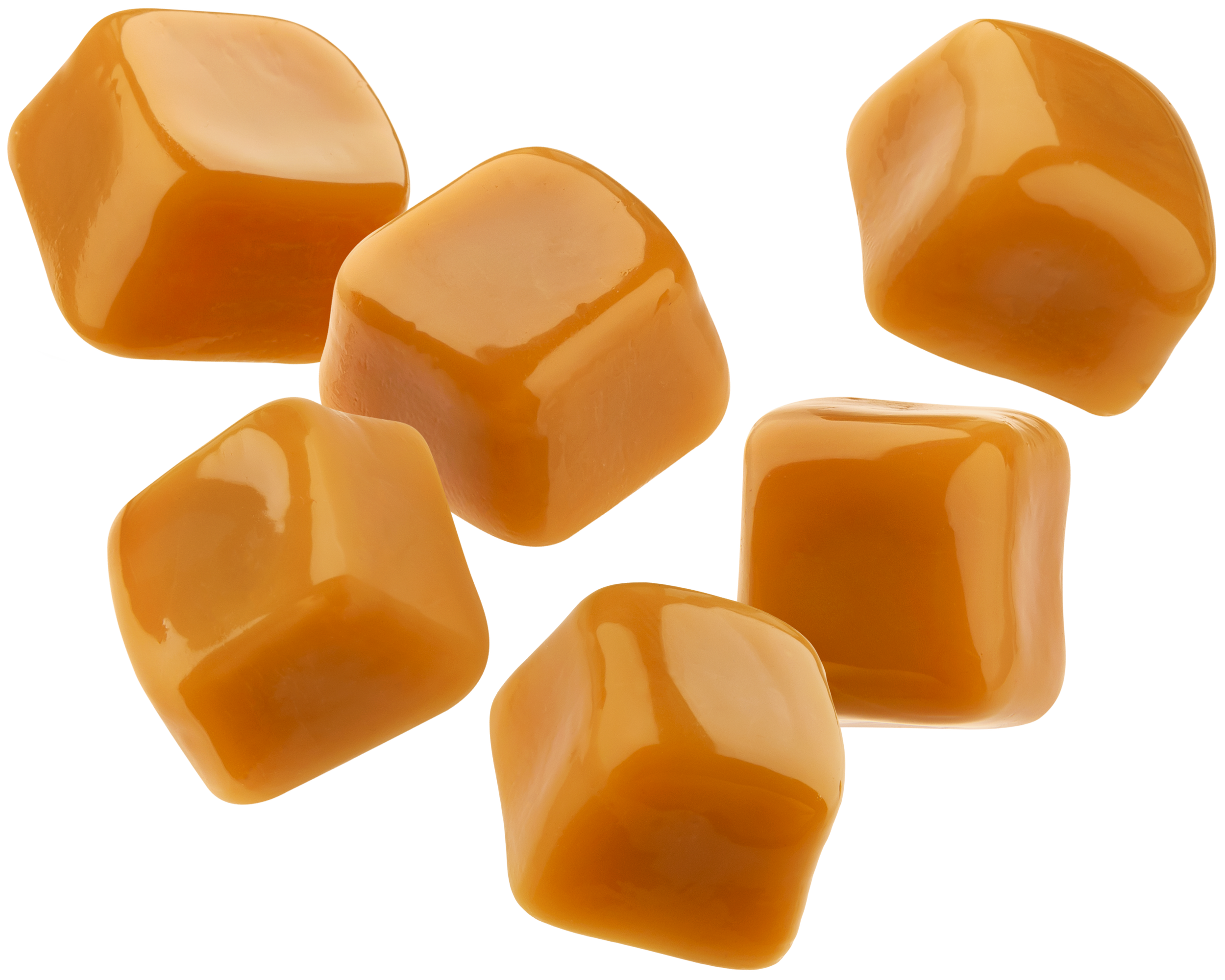 Close-up of several caramel candies with a shiny, smooth surface.
