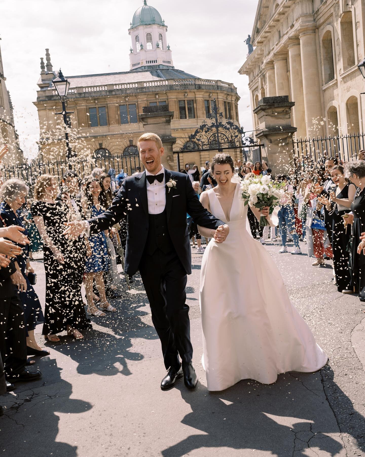 Anna and Graeme, just married, being showered in confetti beneath the Bridge of Sighs in Oxford. It was a great moment - the sun shone, our bagpiper piped and passersby applauded!

Photography: @taylorandporter
Planning and design: @emmajoythewedding