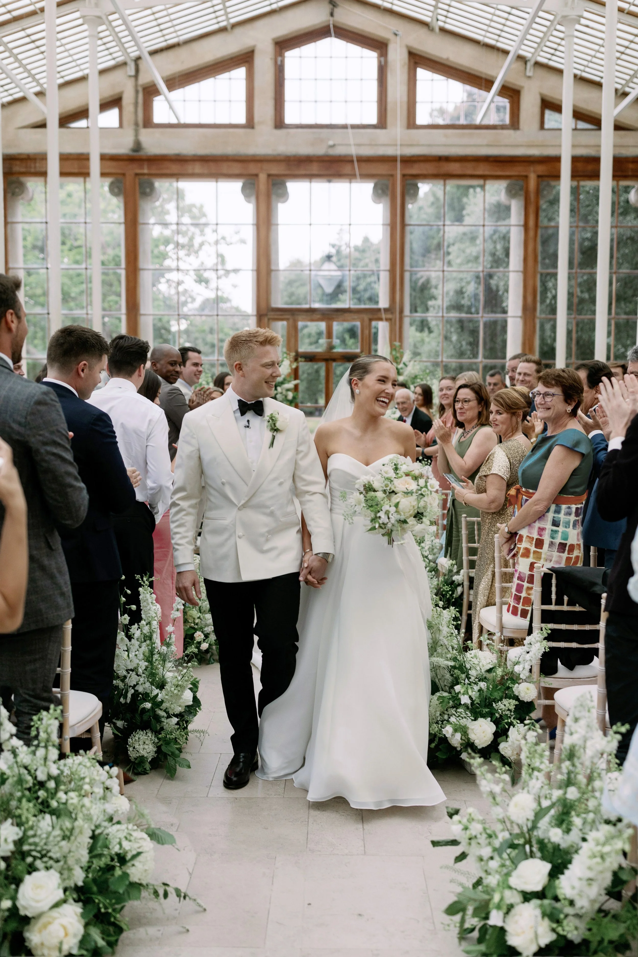 Bride and groom walking down the aisle at Nash Conservatory wedding ceremony