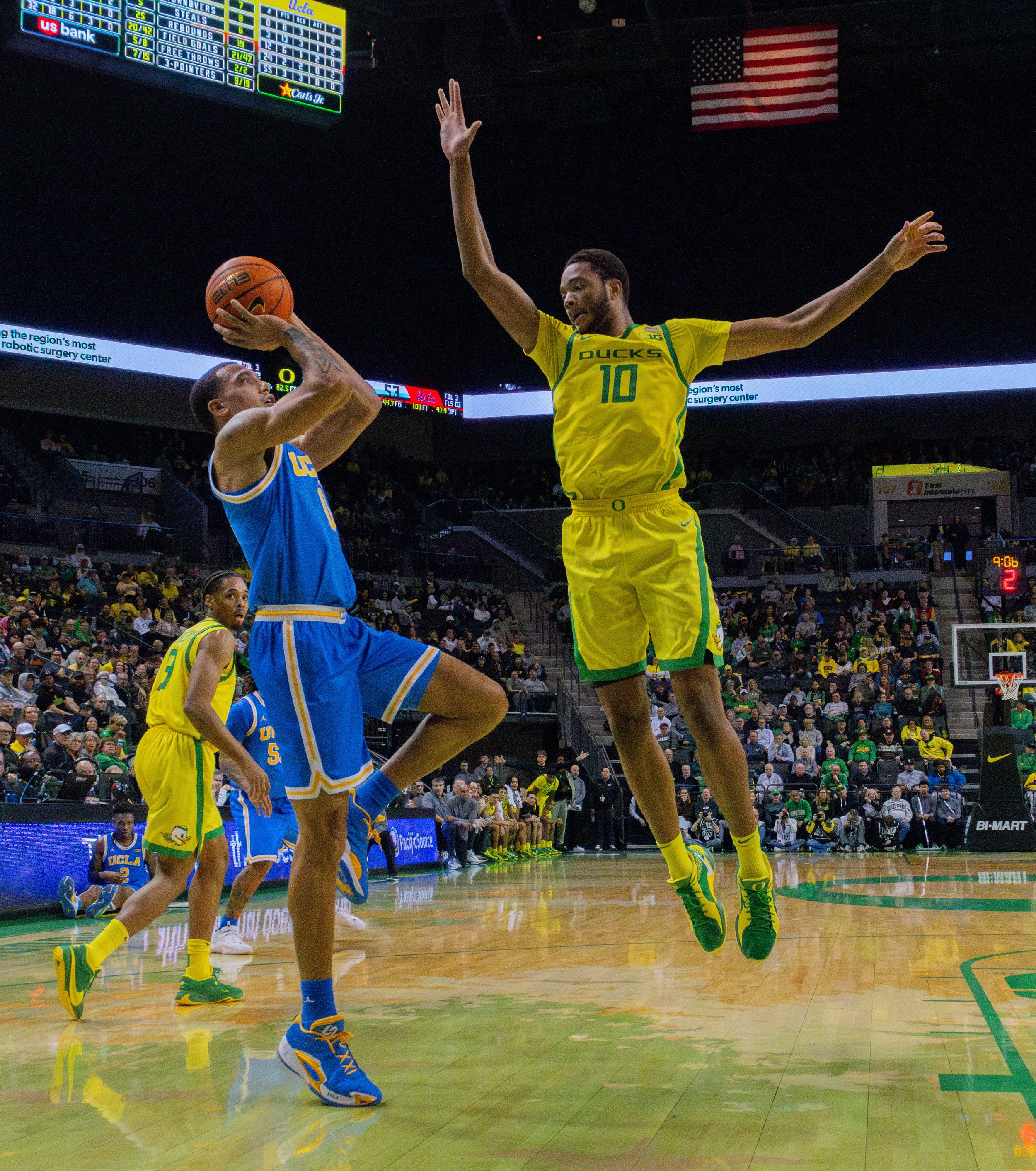 University of Oregon Kwame Evans Jr, #10, flies through the air in an attempt to block UCLA Kobe Johnson, #0, from making a basket. Photo by Emily Manciu