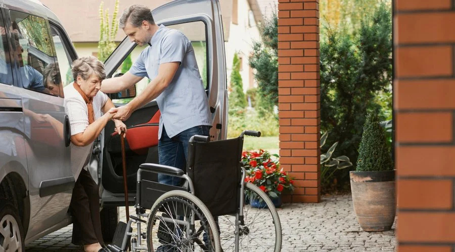 Caregiver-Helping-Transportation-Errands-Home-Care-getting-out-of-car-assistance