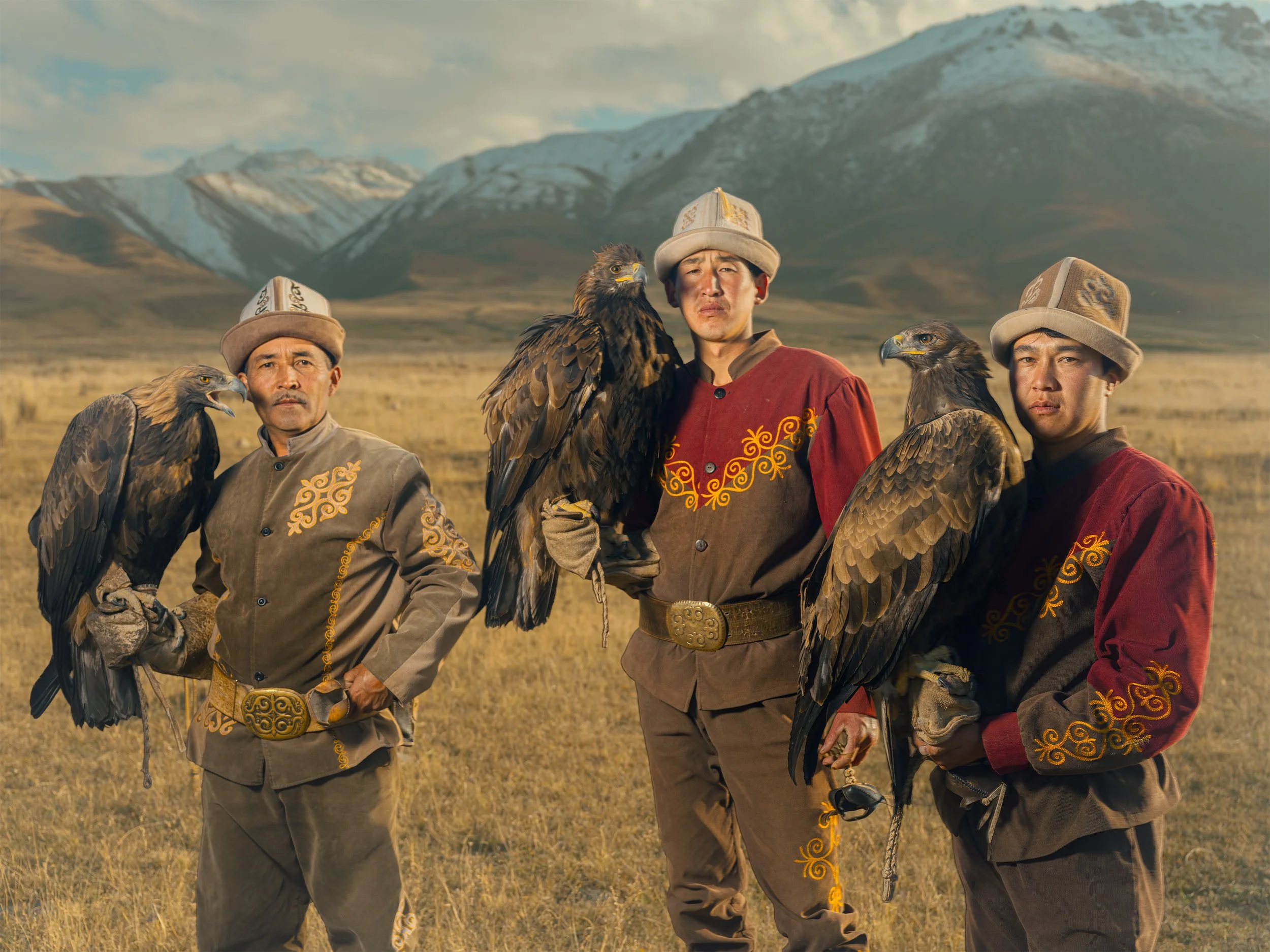 AdamDockerPhotography_Three_EagleHunters_Kyrgystan_GoldenEagles_TienShan_Hero_Portrait.jpg
