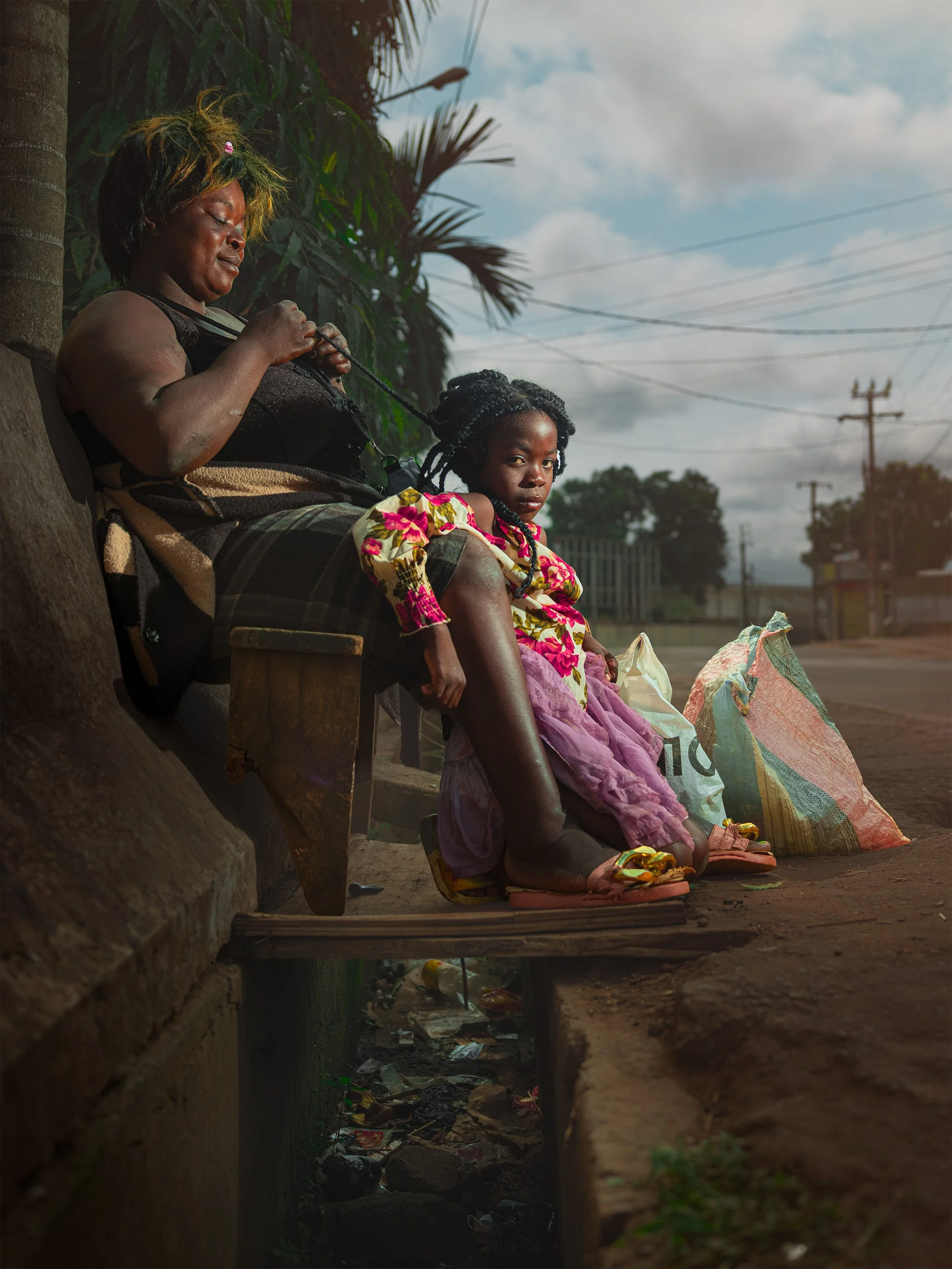 Mother braiding daughter's hair - Yaoundé, Cameroon