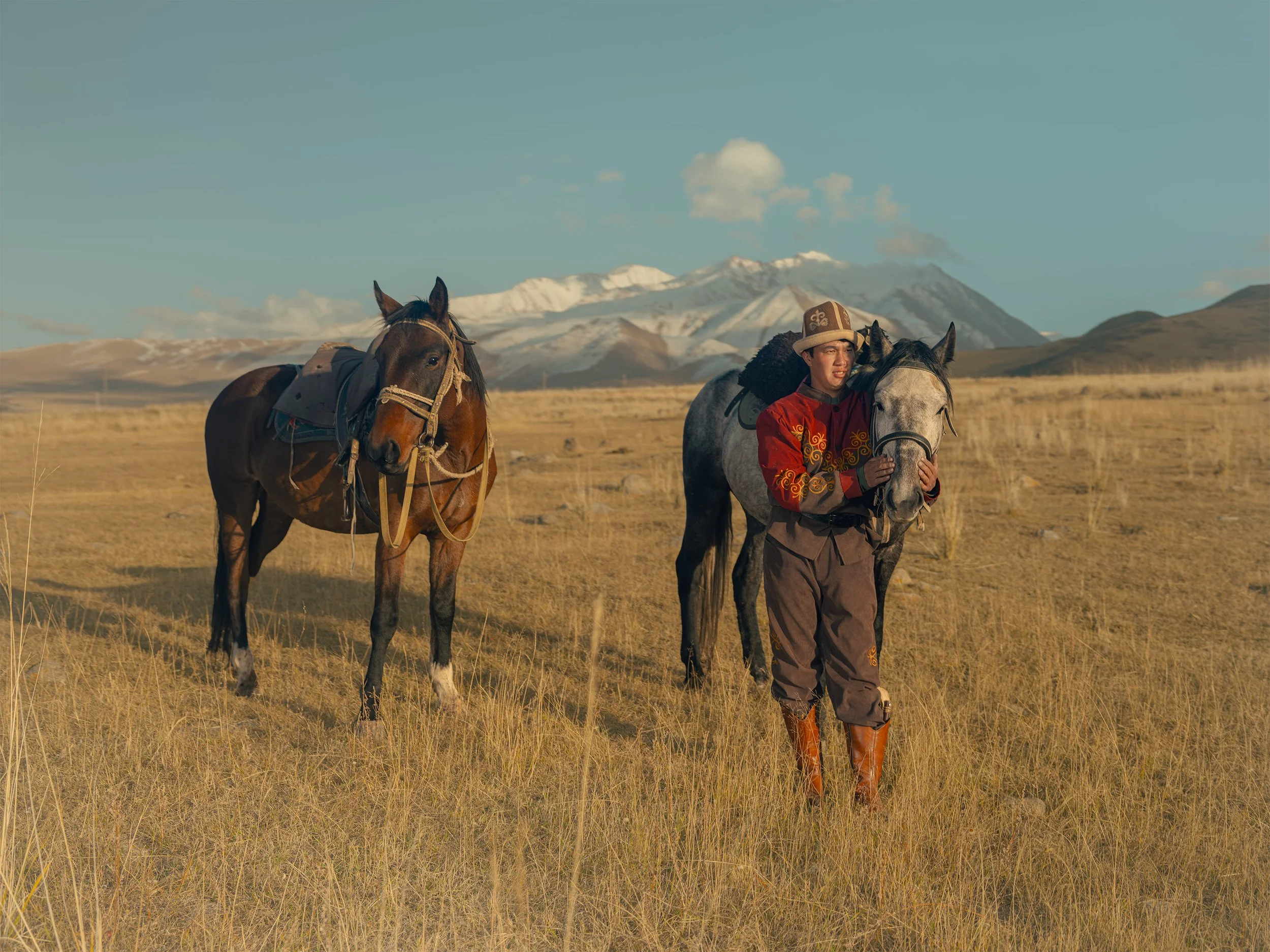 AdamDockerPhotography_EagleHunters_Kyrgystan_GoldenEagle_Caring_TwoHorses.jpg