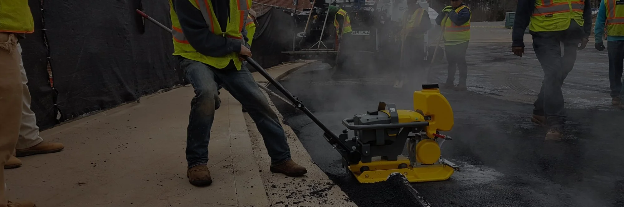 Crew finishing a concrete slab with power trowels rented from XUMA