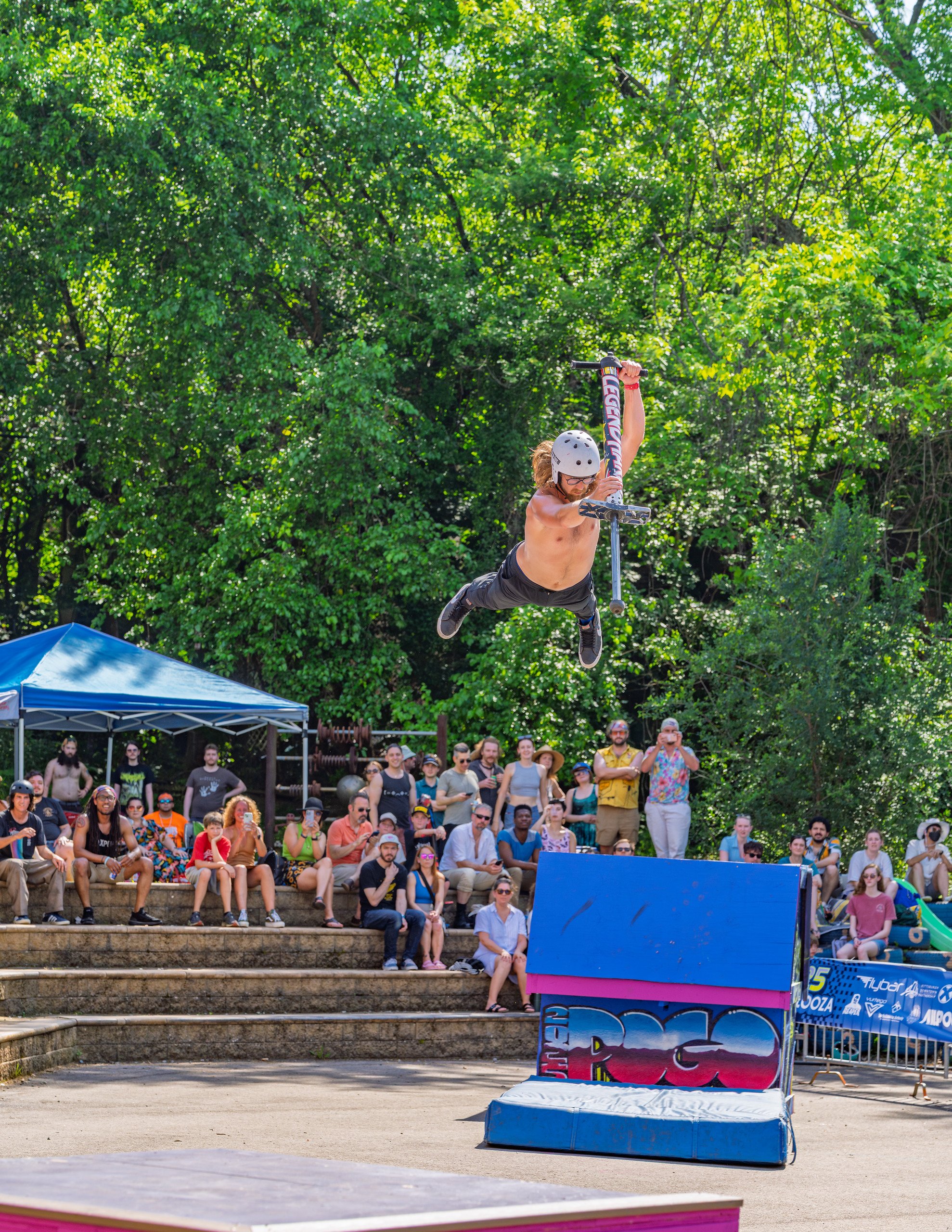Xpogo Stunt Team performing a pogo stick backflip in front of a baseball crowd — available for booking in Nashville, TN