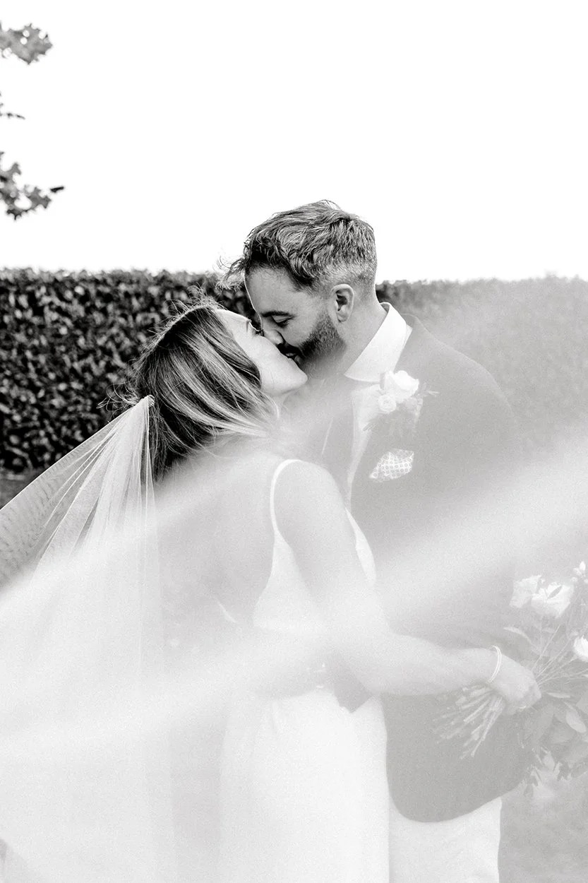 bride and groom veil kiss during wedding portraits at talbooth house wedding essex