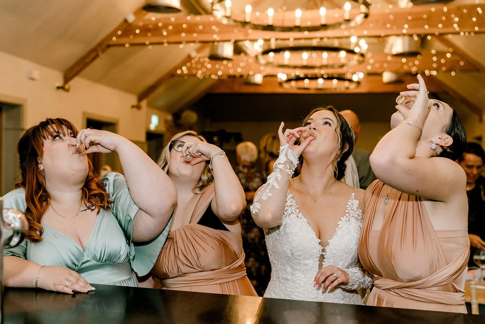 bride enjoying alcohol shots with friends at apton hall essex