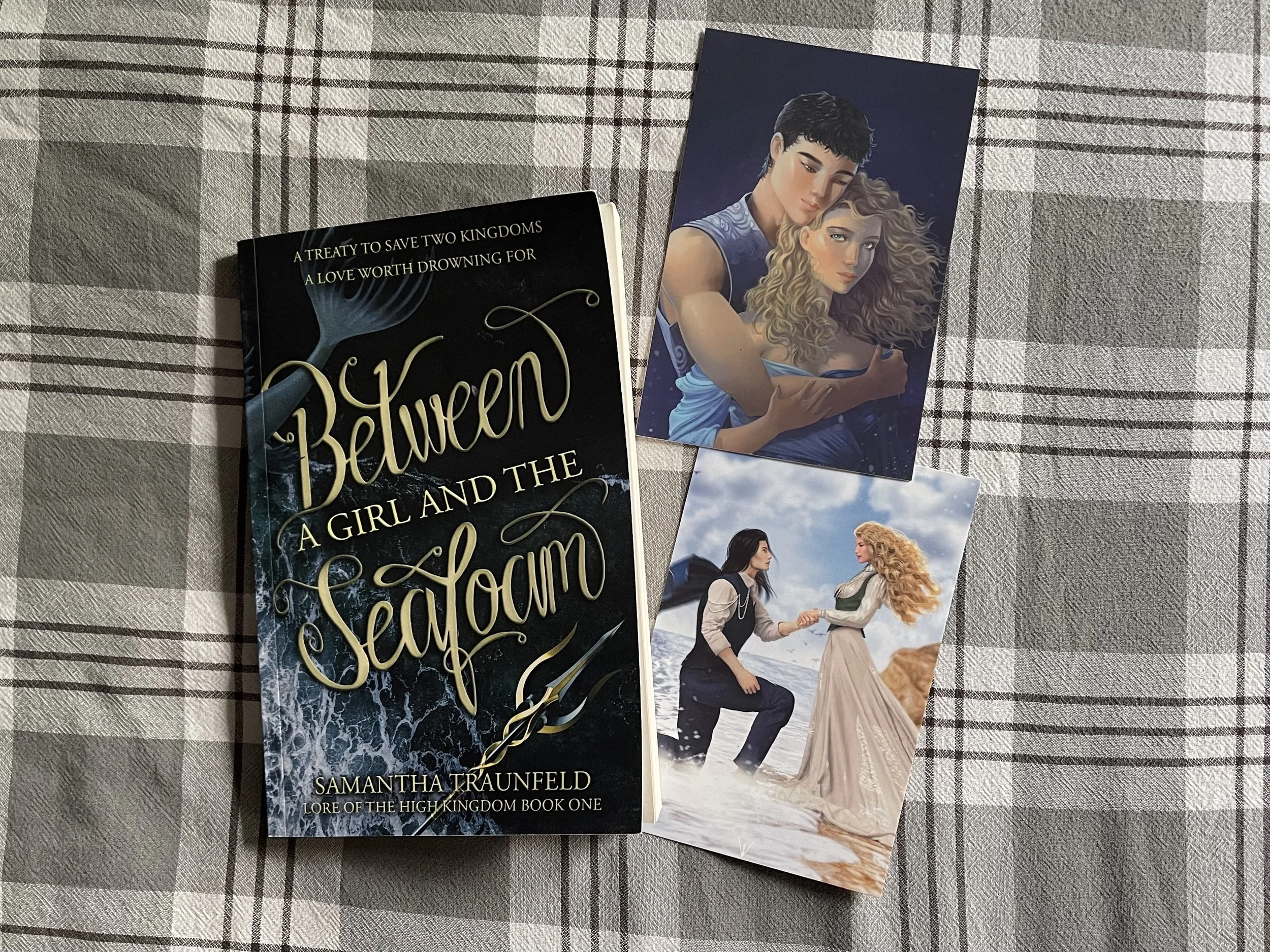 A book with two character art postcards