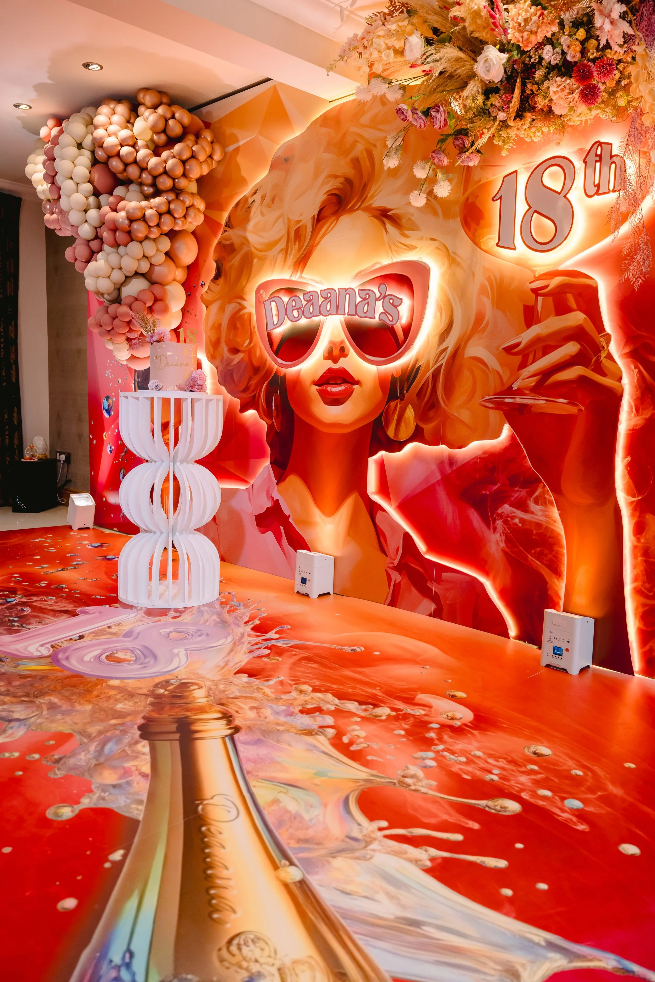 18th birthday celebration, custom printed backdrop, themed event, floral dressing, LED backdrop, cake table, custom floor print