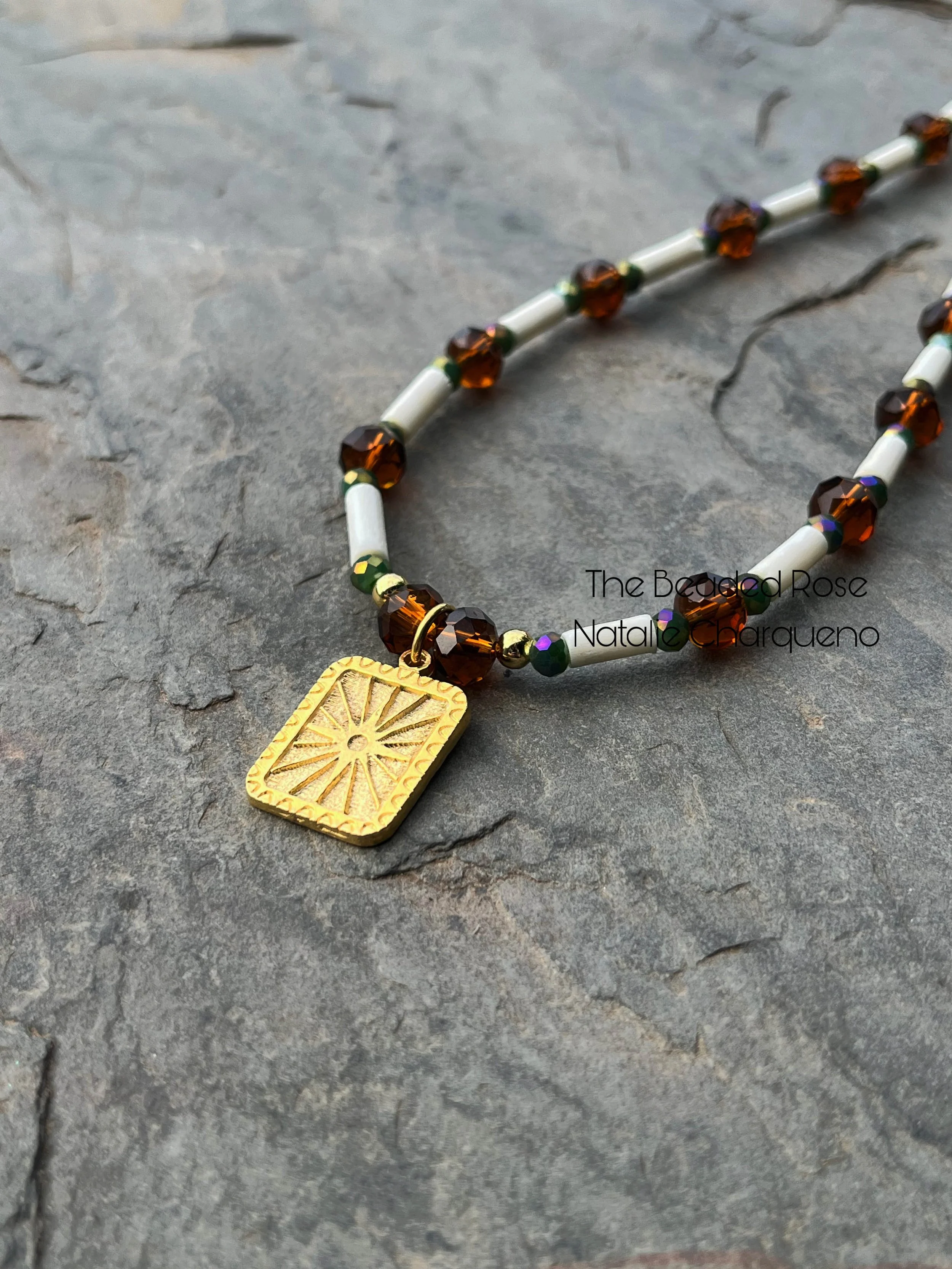gold browna dn white necklace sun charm.jpg