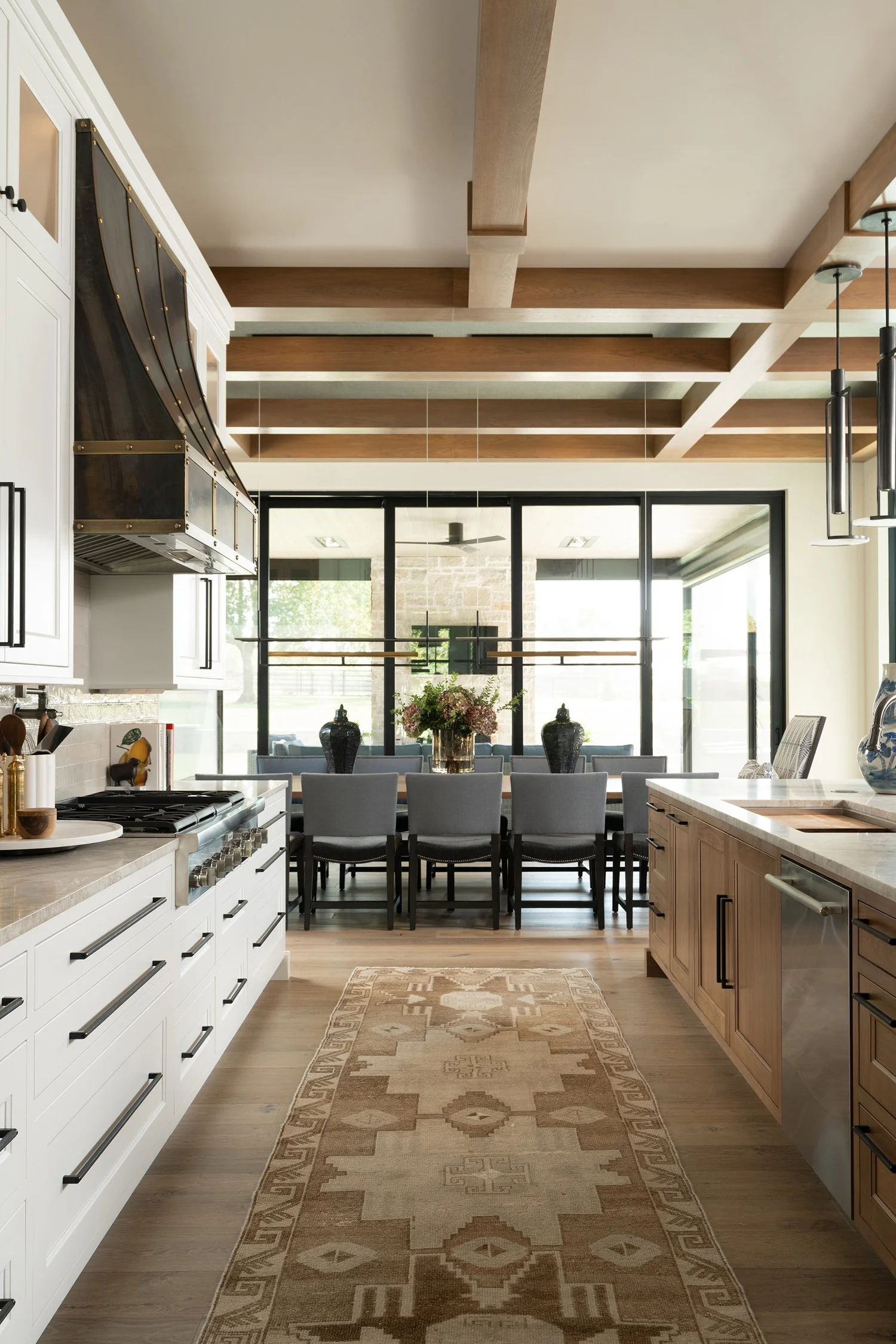 Kitchen renovation by Obelisk Home with custom cabinetry, island seating, and layered finishes